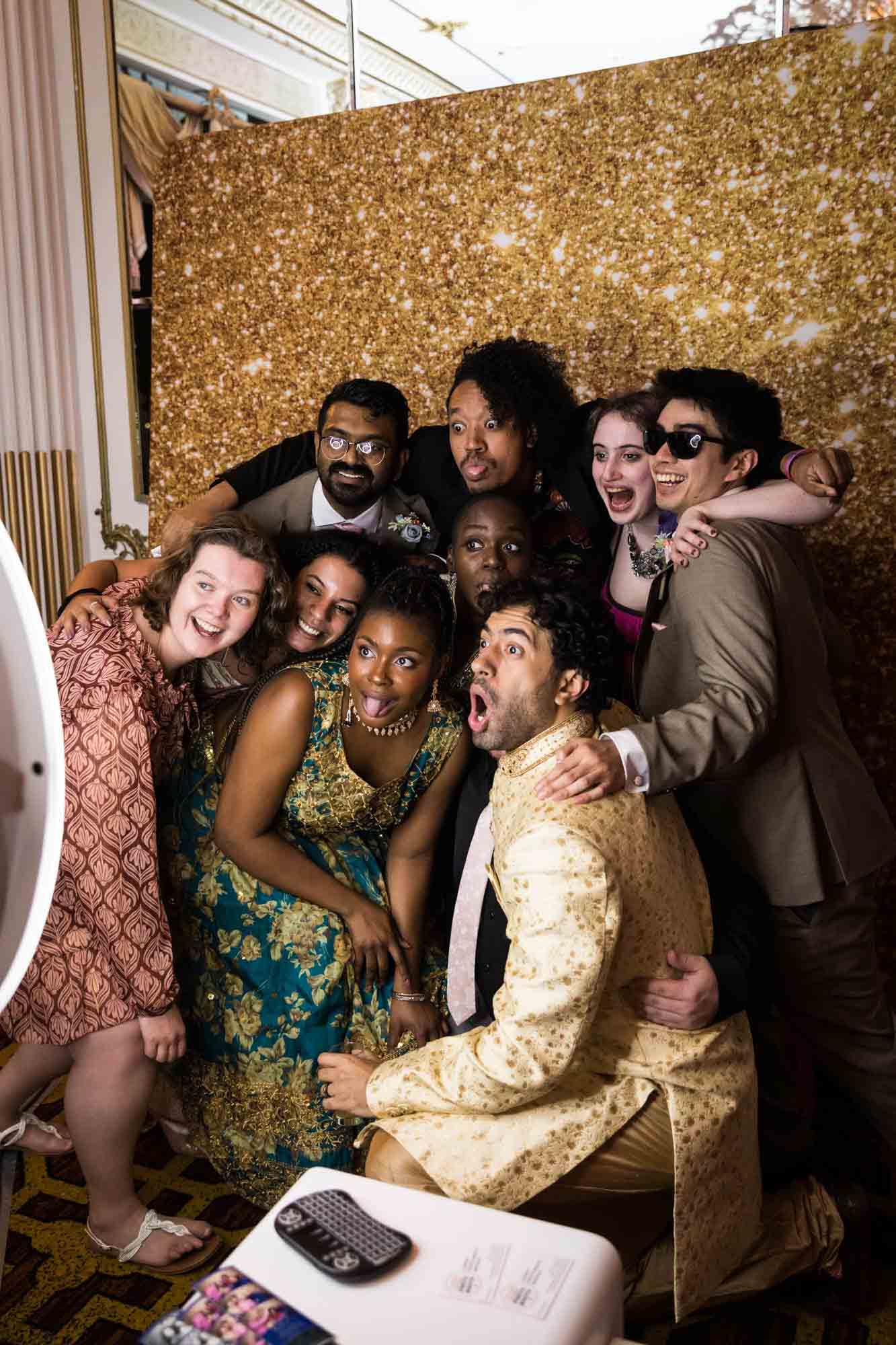 Large group of friends making funny faces in photo booth for an article on Terrace on the Park wedding photo tips