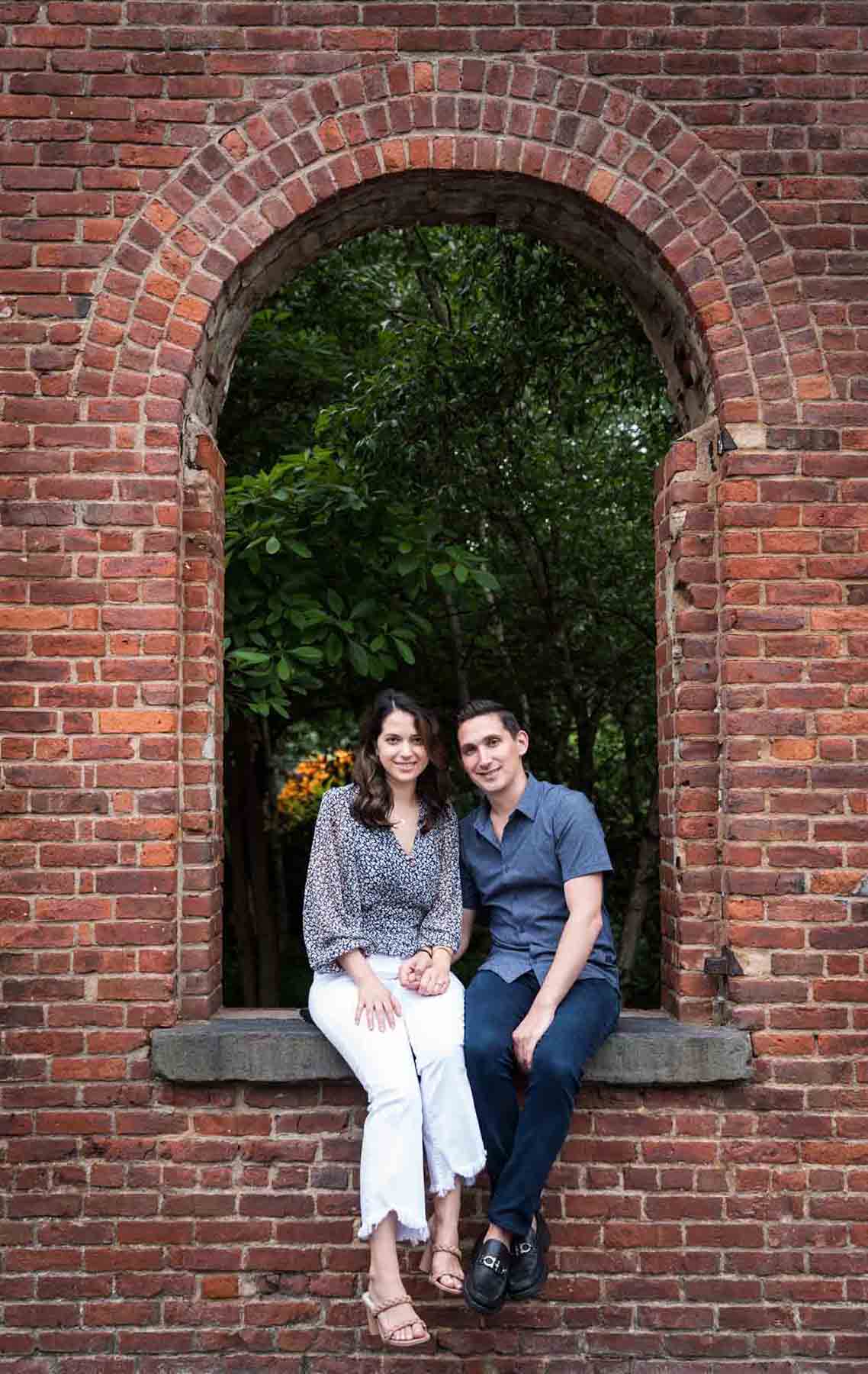 Couple sitting together in brick archway in Brooklyn Bridge Park