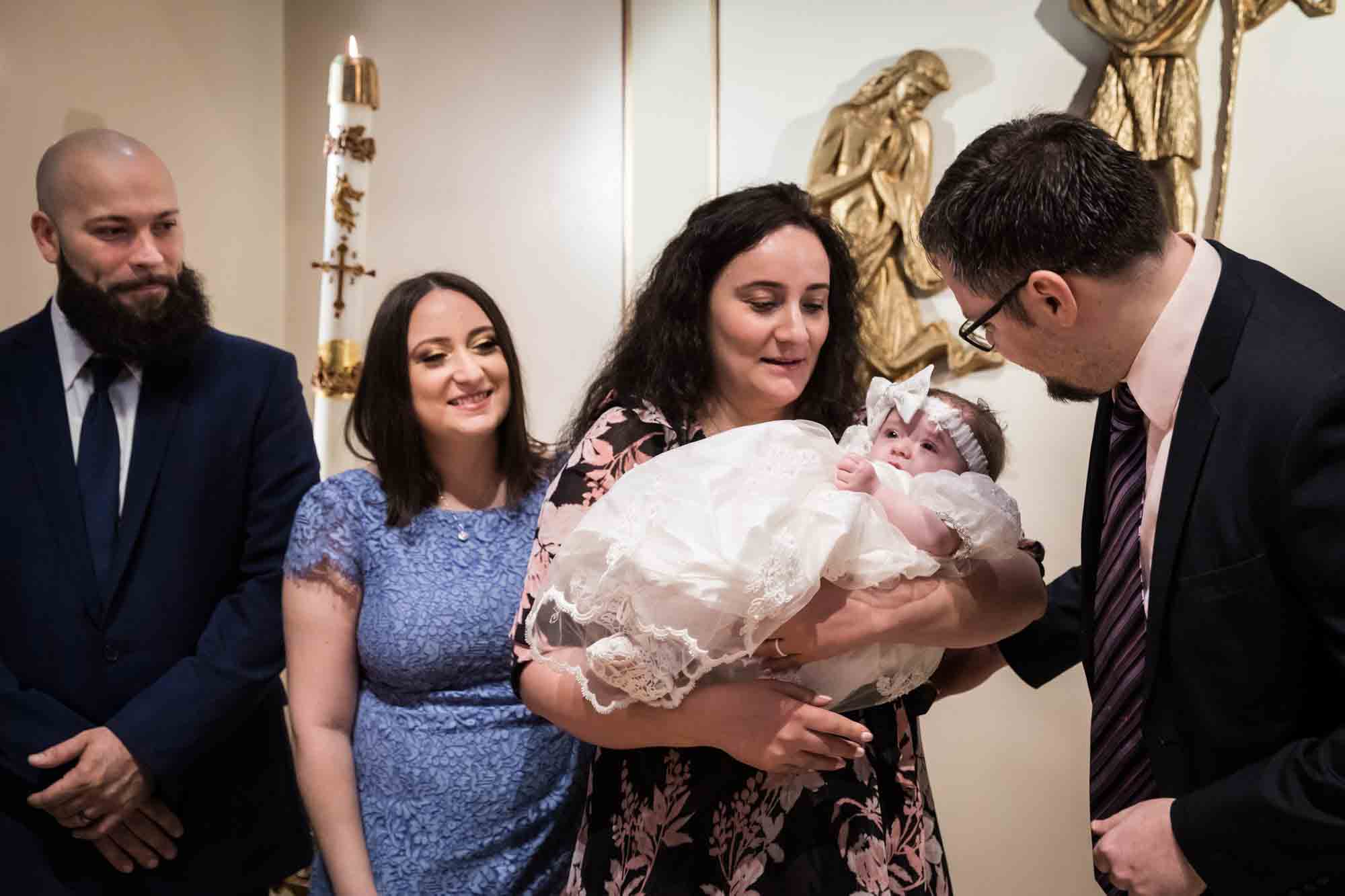 Maspeth baptism photos of family looking at baby after ceremony