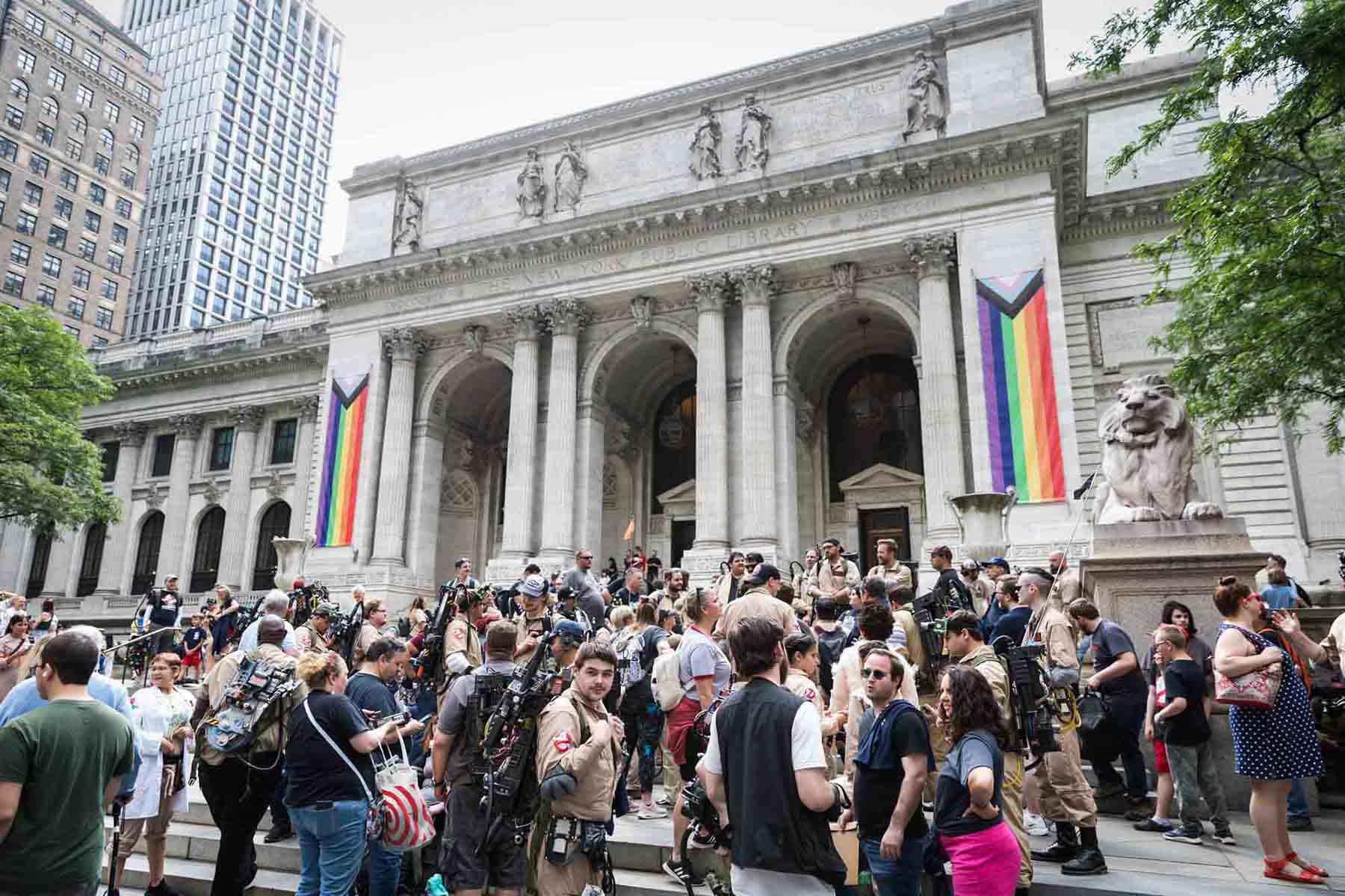 Mop of people in costume outside the New York Public Library to celebrate the 37th year of the movie Ghostbusters