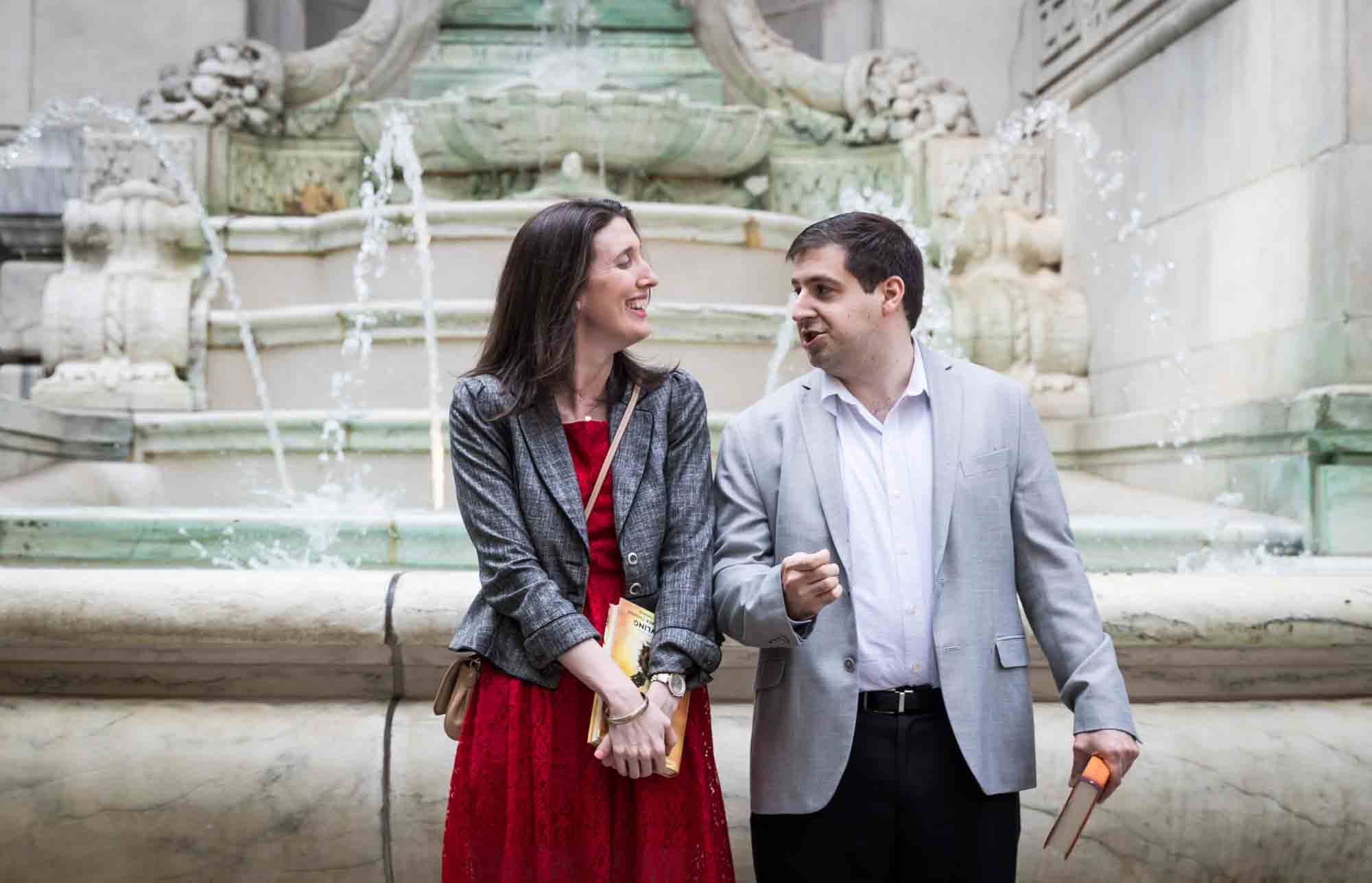 Couple standing in front of 'Beauty' fountain during a New York Public Library surprise proposal