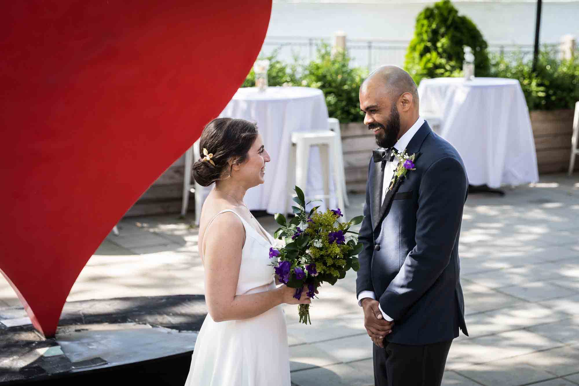 Bride and groom seeing each other during first look on patio at a Sanctuary Roosevelt Island wedding