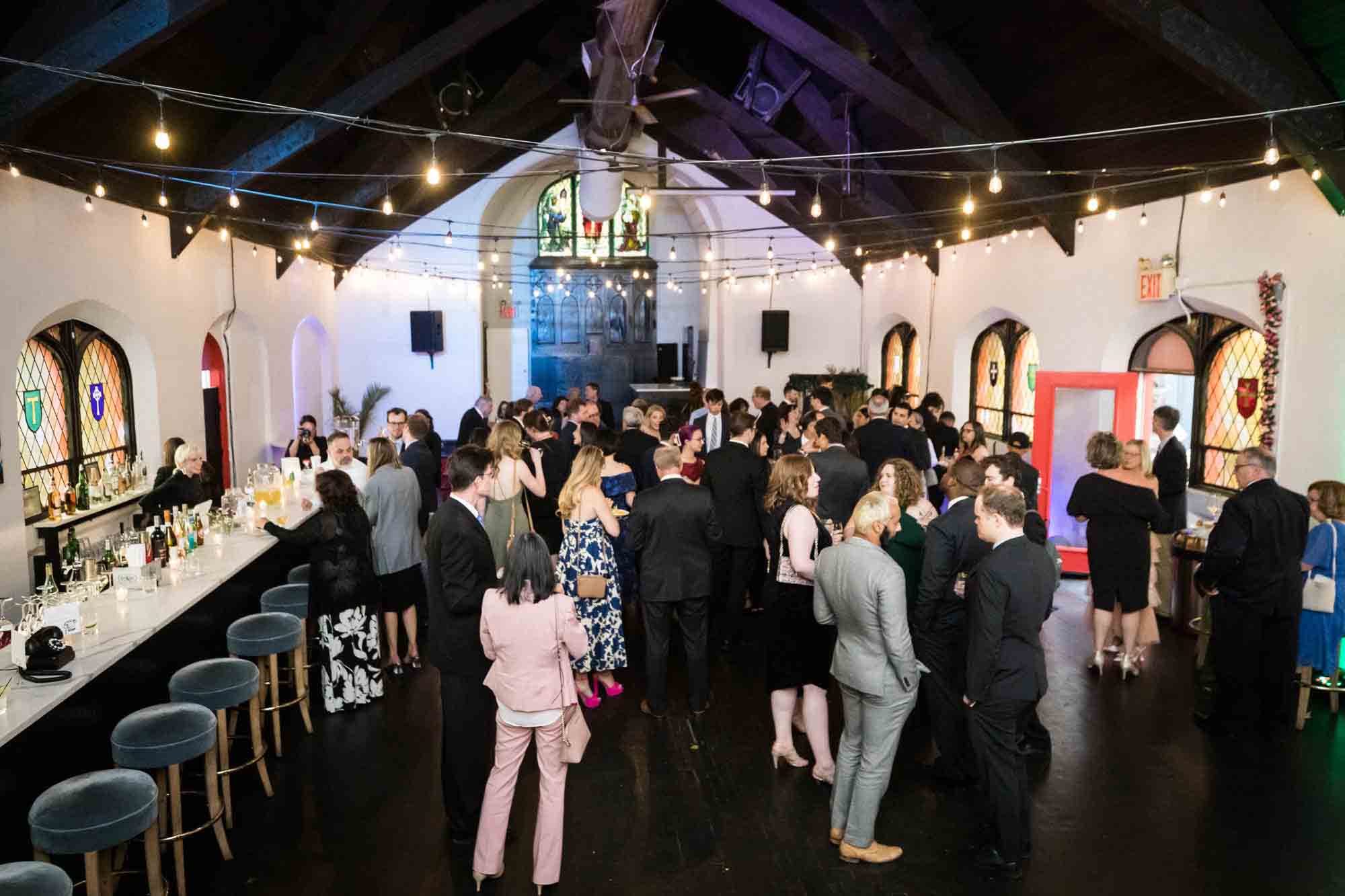 Guests enjoying cocktail hour inside sanctuary space at a Sanctuary Roosevelt Island wedding