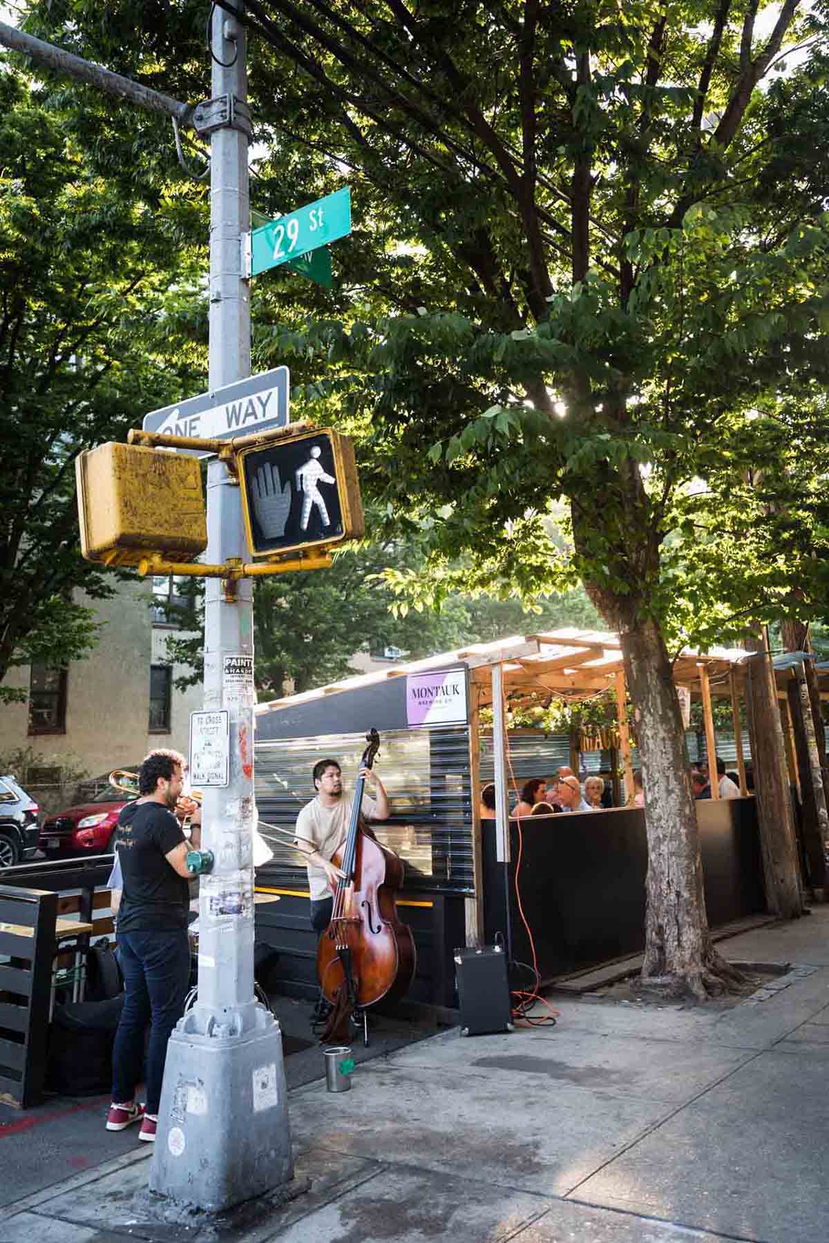 Jazz band playing on sidewalk corner outside of Macoletta Restaurant in Astoria