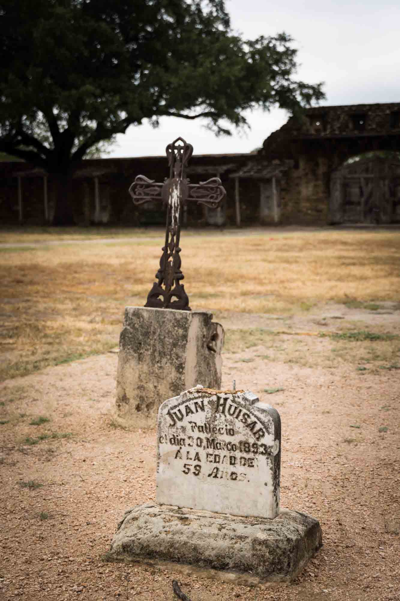 Gravestone and metal cross at Mission San Juan in San Antonio