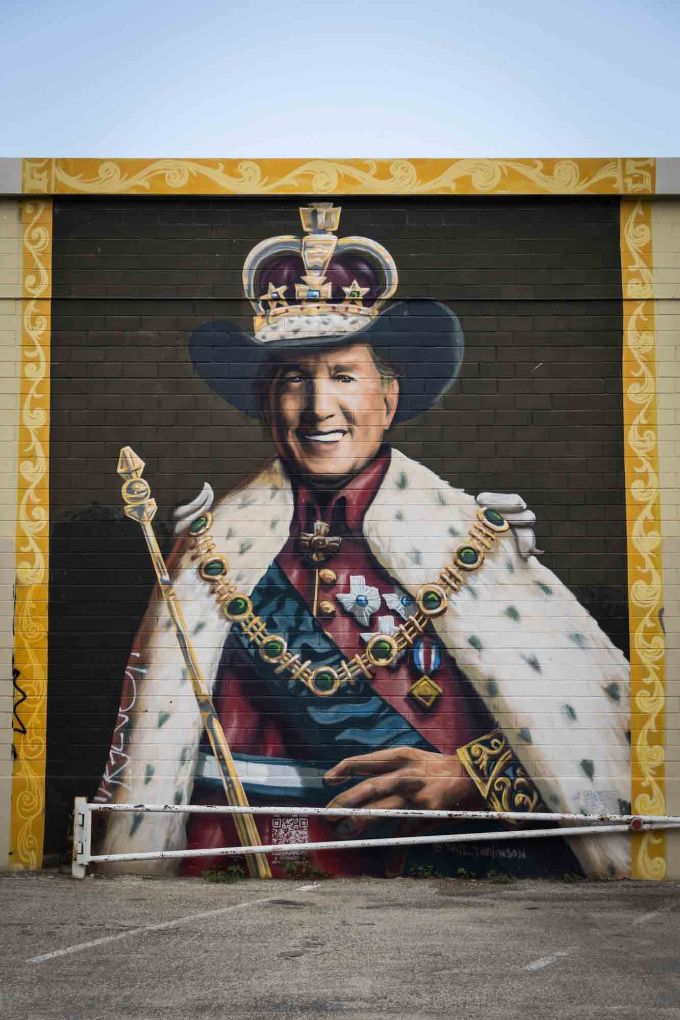 Mural of man dressed as king with cowboy hat on wall in San Antonio