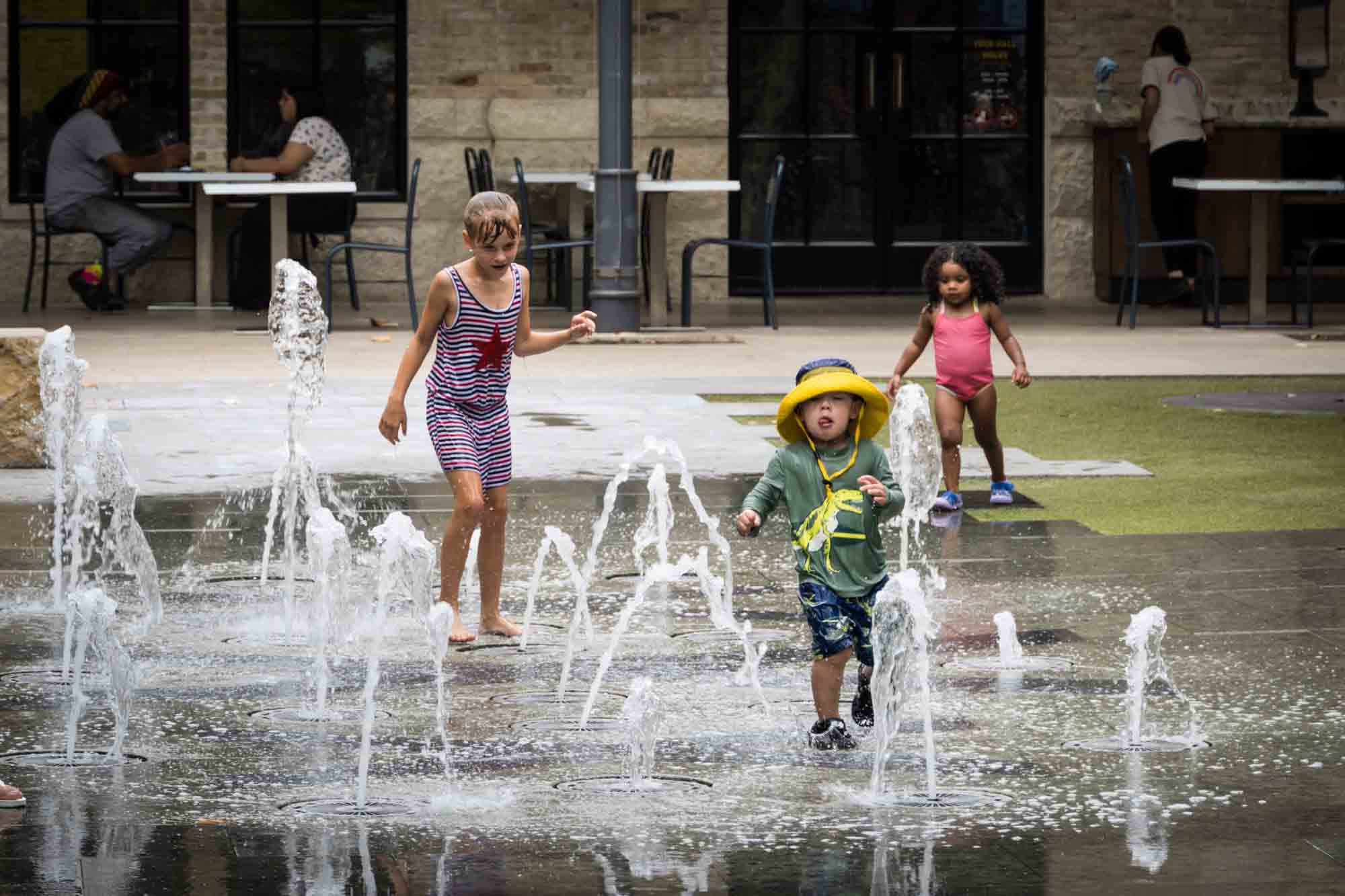 Three children playing in fountains at The Pearl l in San Antonio