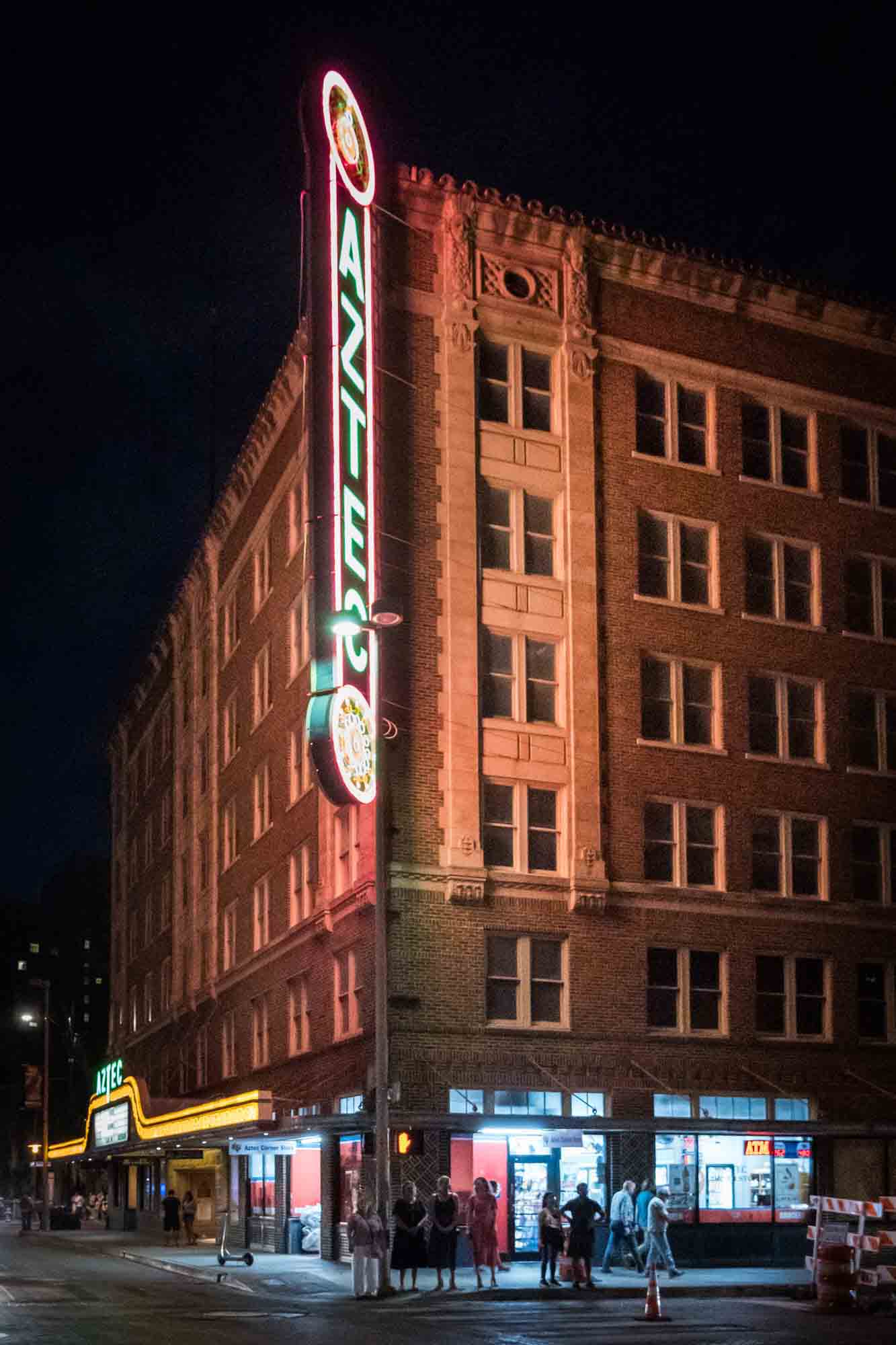 Aztec Theatre neon sign lit up at night in San Antonio