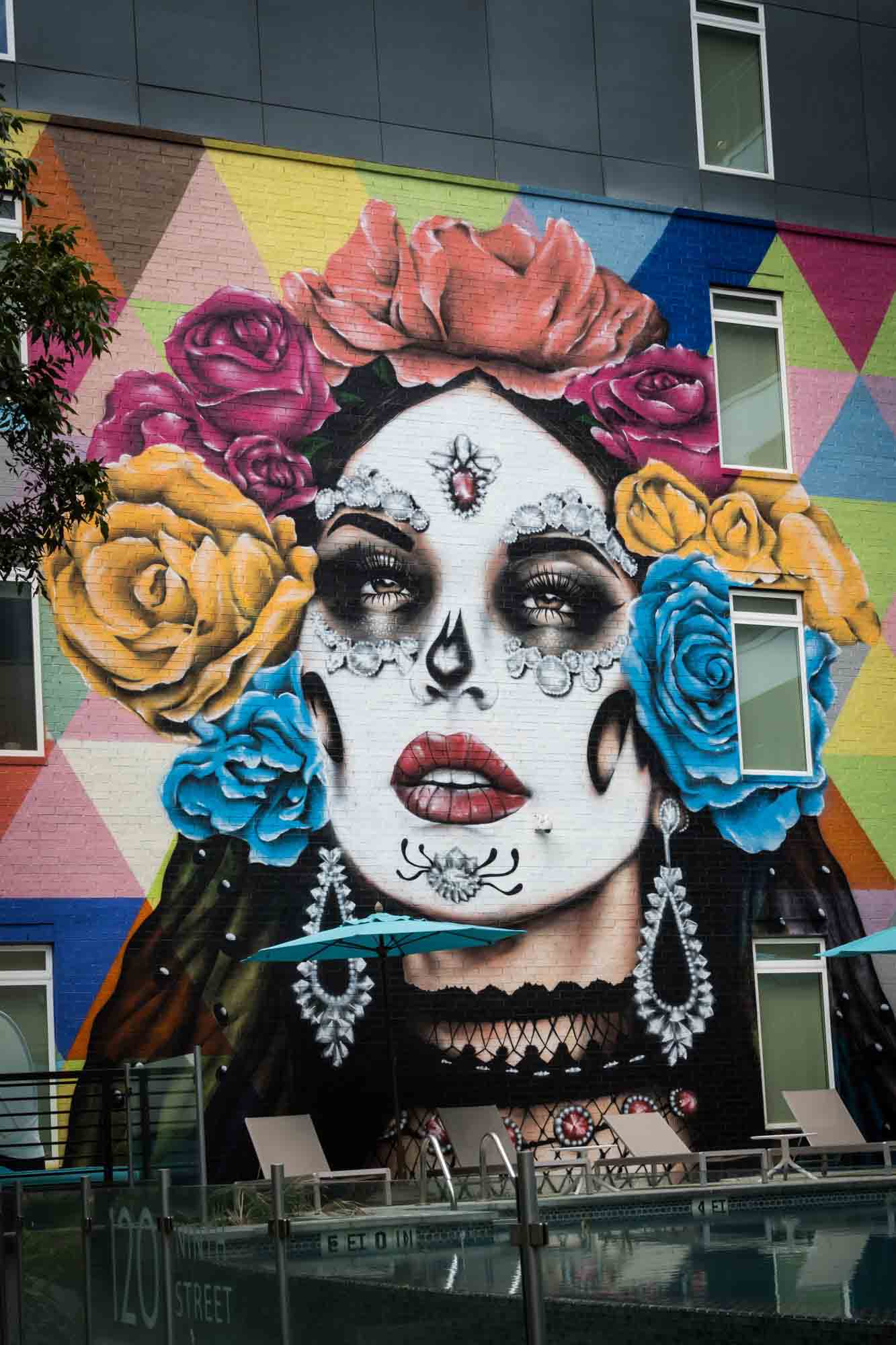 Colorful mural of woman wearing skull paint and colorful flowers in her hair in San Antonio