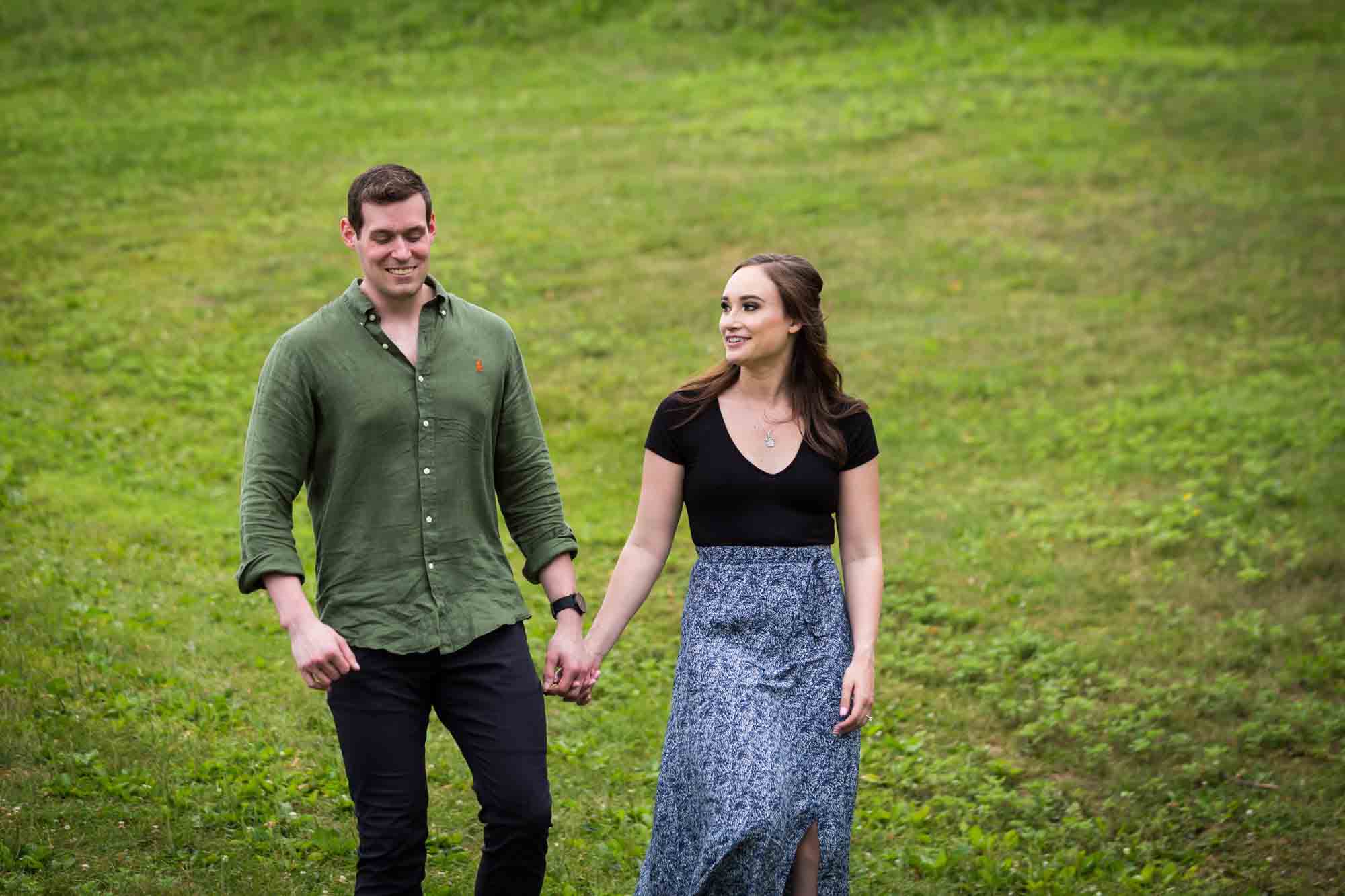 Couple walking in grass at the Vanderbilt Museum