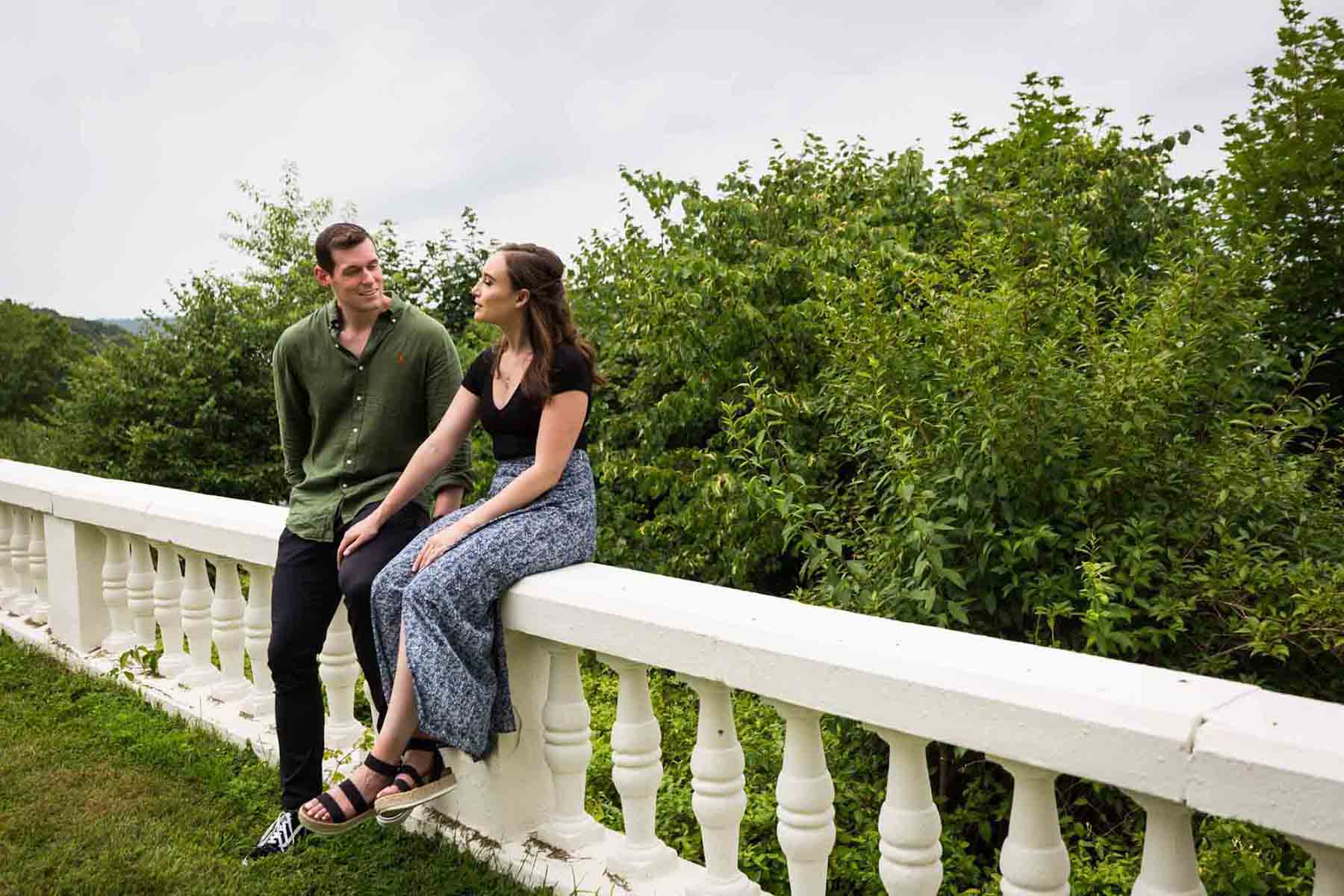 Couple sitting on stone railing at the Vanderbilt Museum