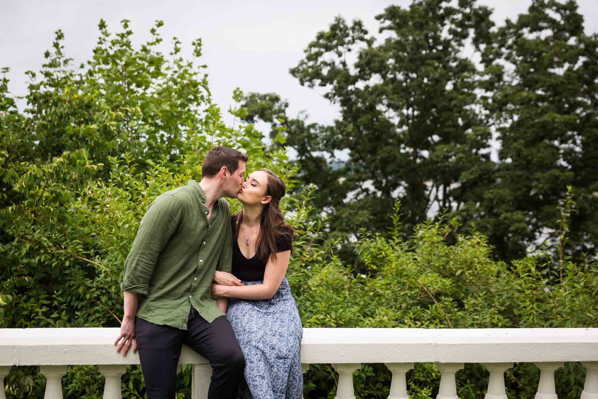 Couple kissing on railing at the Vanderbilt Museum