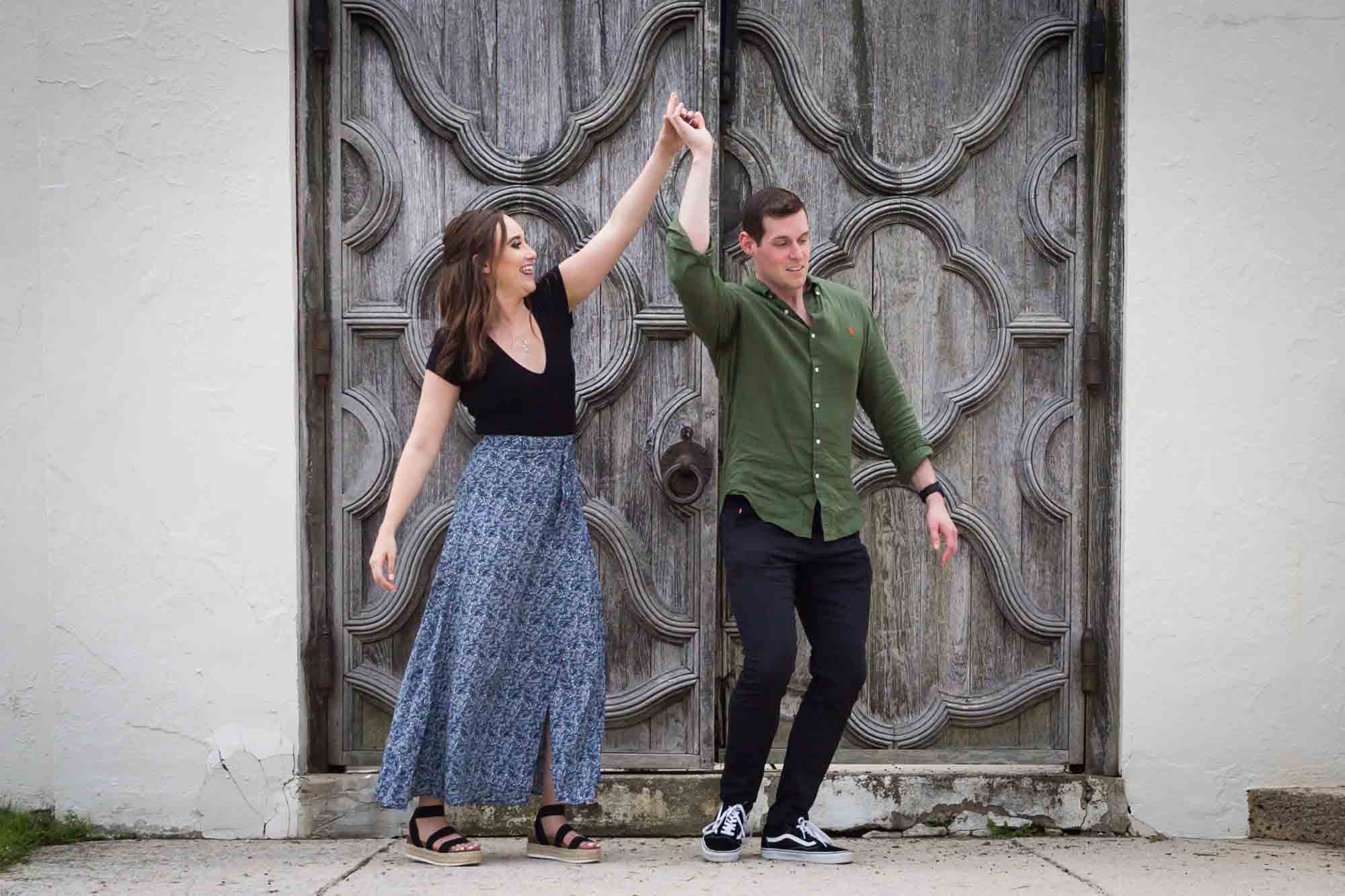 Couple dancing in front of wooden door at the Vanderbilt Museum
