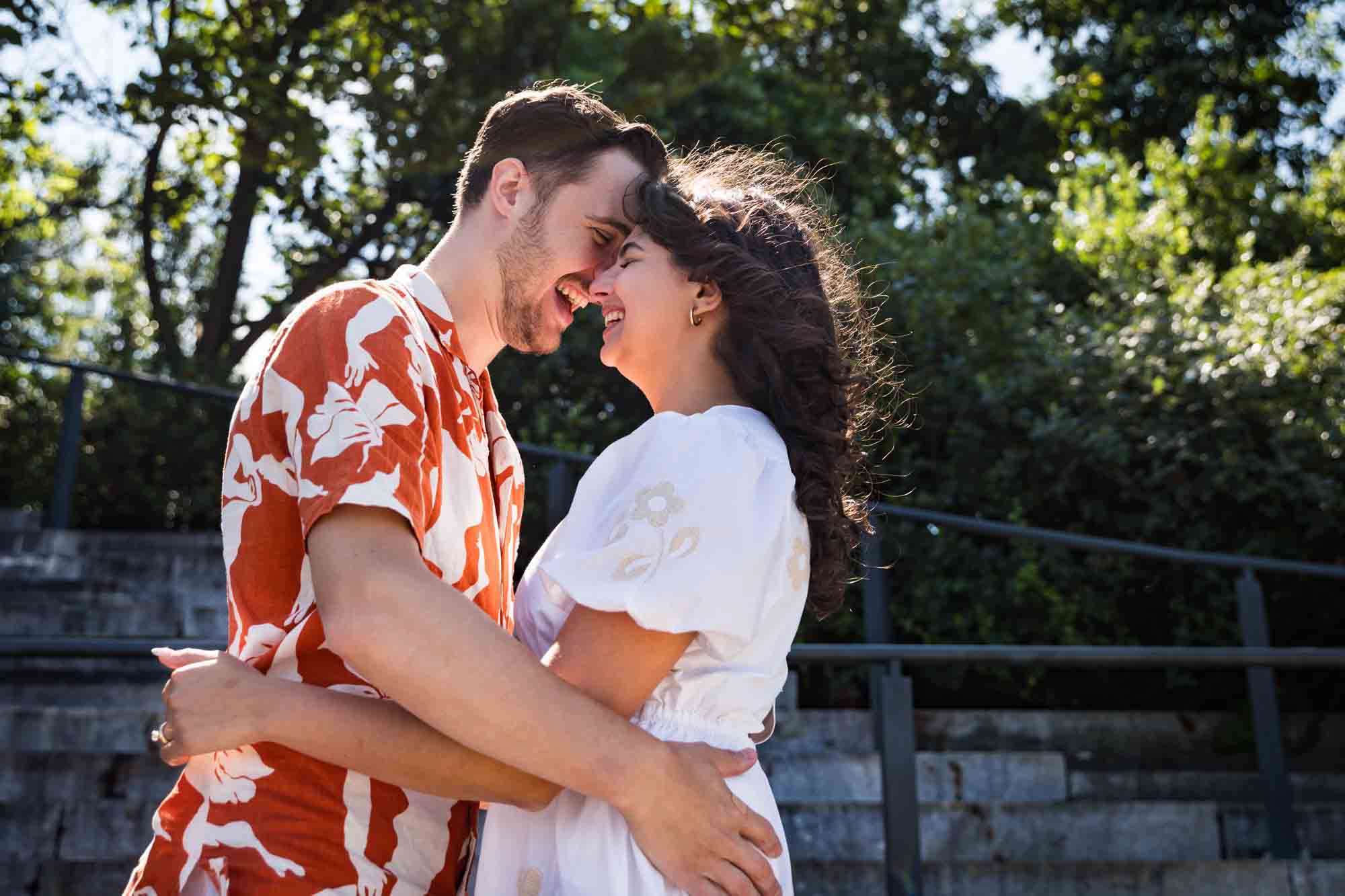 Couple hugging forehead-to-forehead in Brooklyn Bridge Park