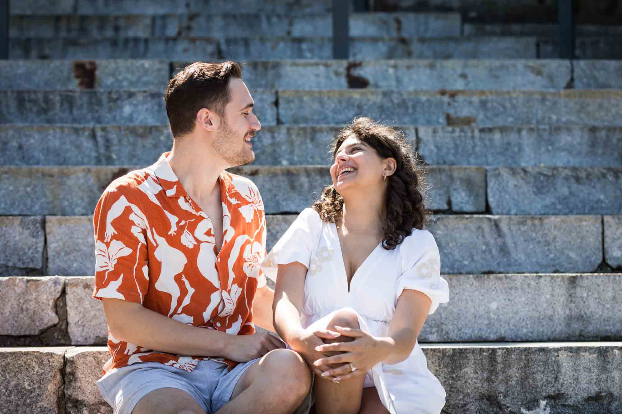 Couple laughing on Granite Steps in Brooklyn Bridge Park