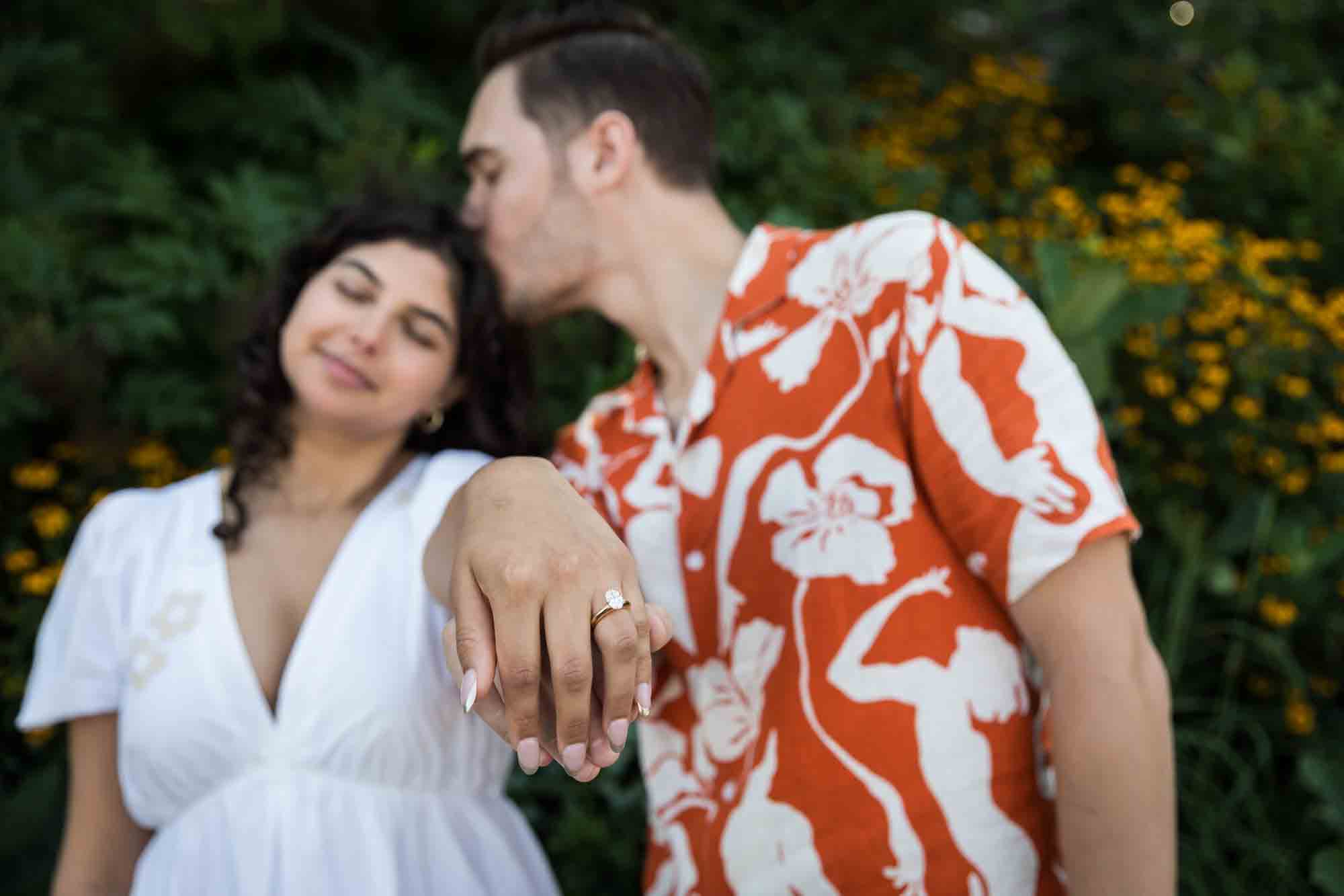 Couple showing off engagement ring on woman's hand