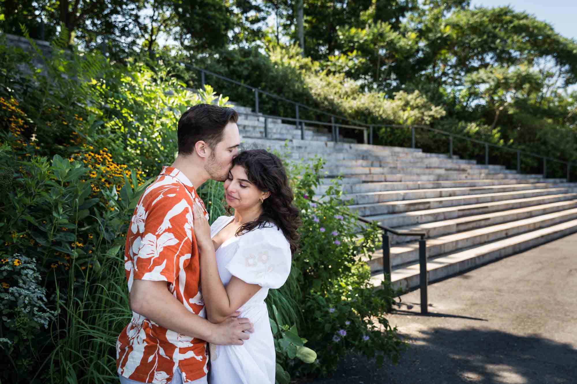 Couple hugging in front of Granite Steps in Brooklyn Bridge Park