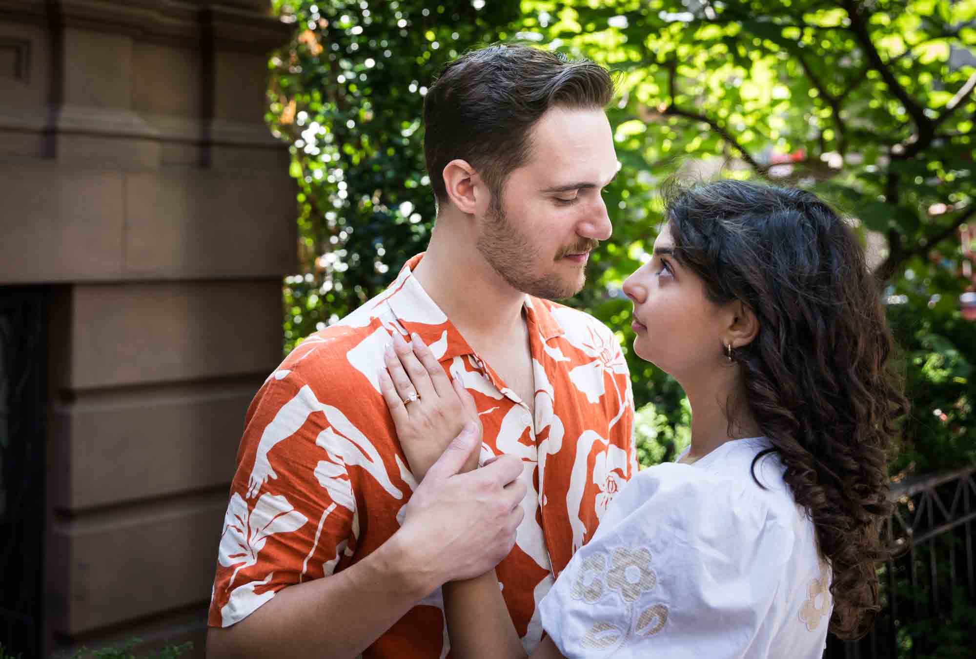 Couple looking at each other with woman's hand on man's chest