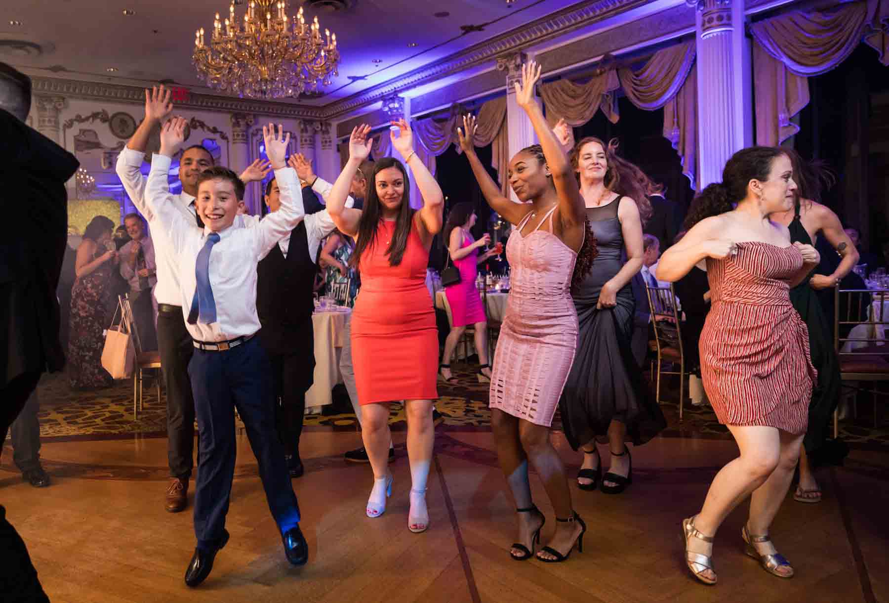 Guests dancing with arms raised at a Terrace on the Park wedding