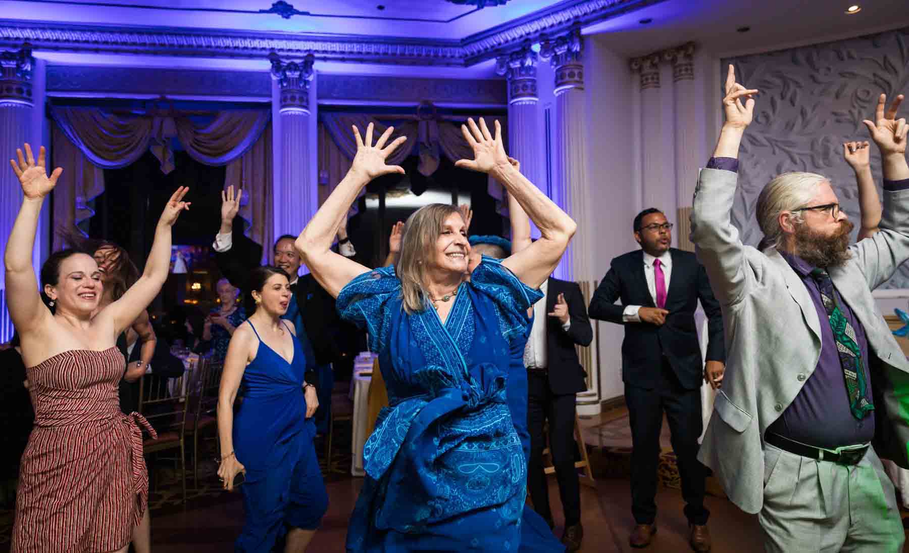 Guests dancing with arms raised at a Terrace on the Park wedding