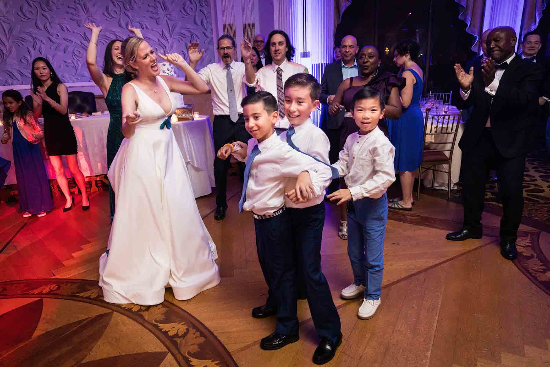 Three little boys dancing in front of bride and guests on dance floor at a Terrace on the Park wedding