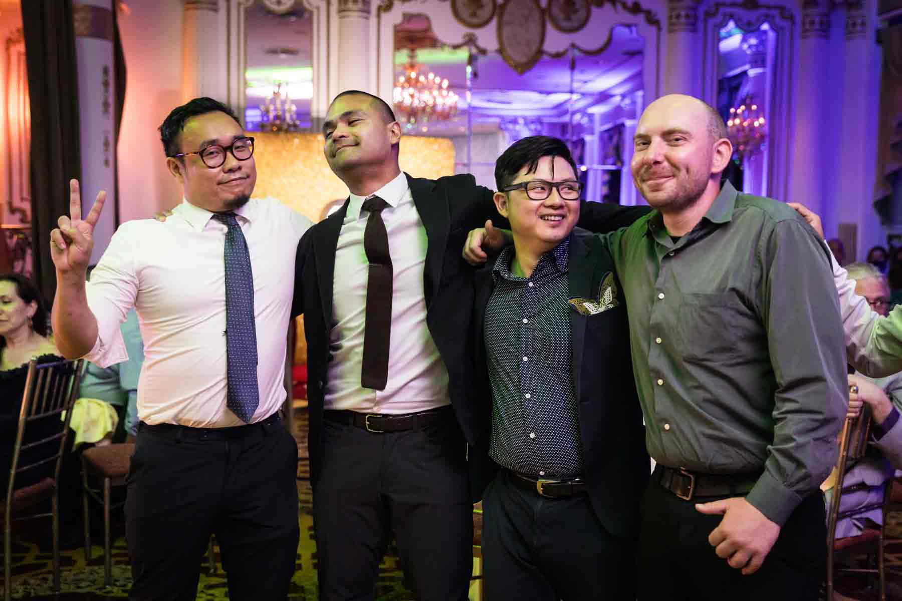 Four men embracing on the dance floor at a Terrace on the Park wedding