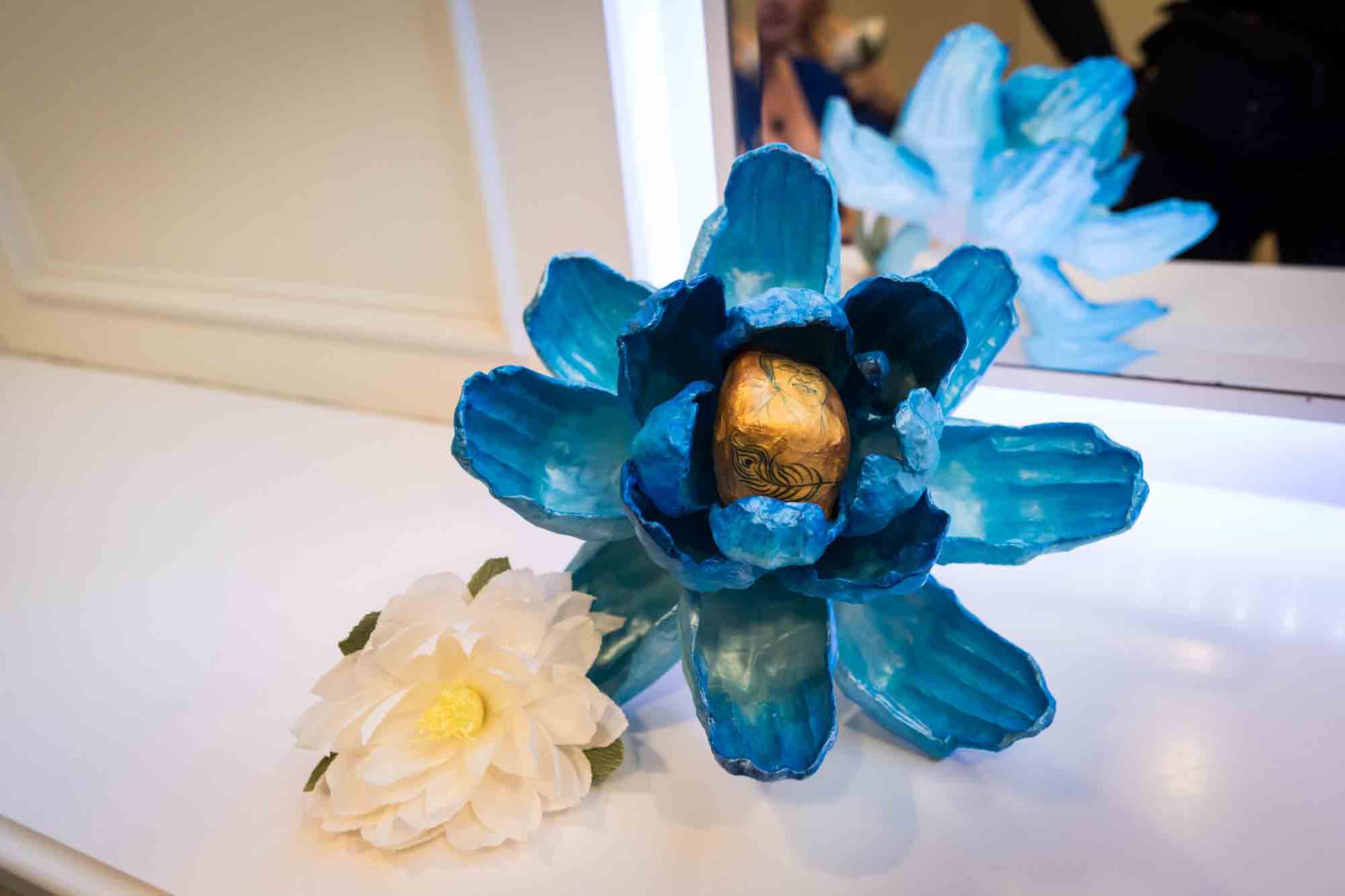 Close up of blue flower bouquet made of paper mache and white paper flower