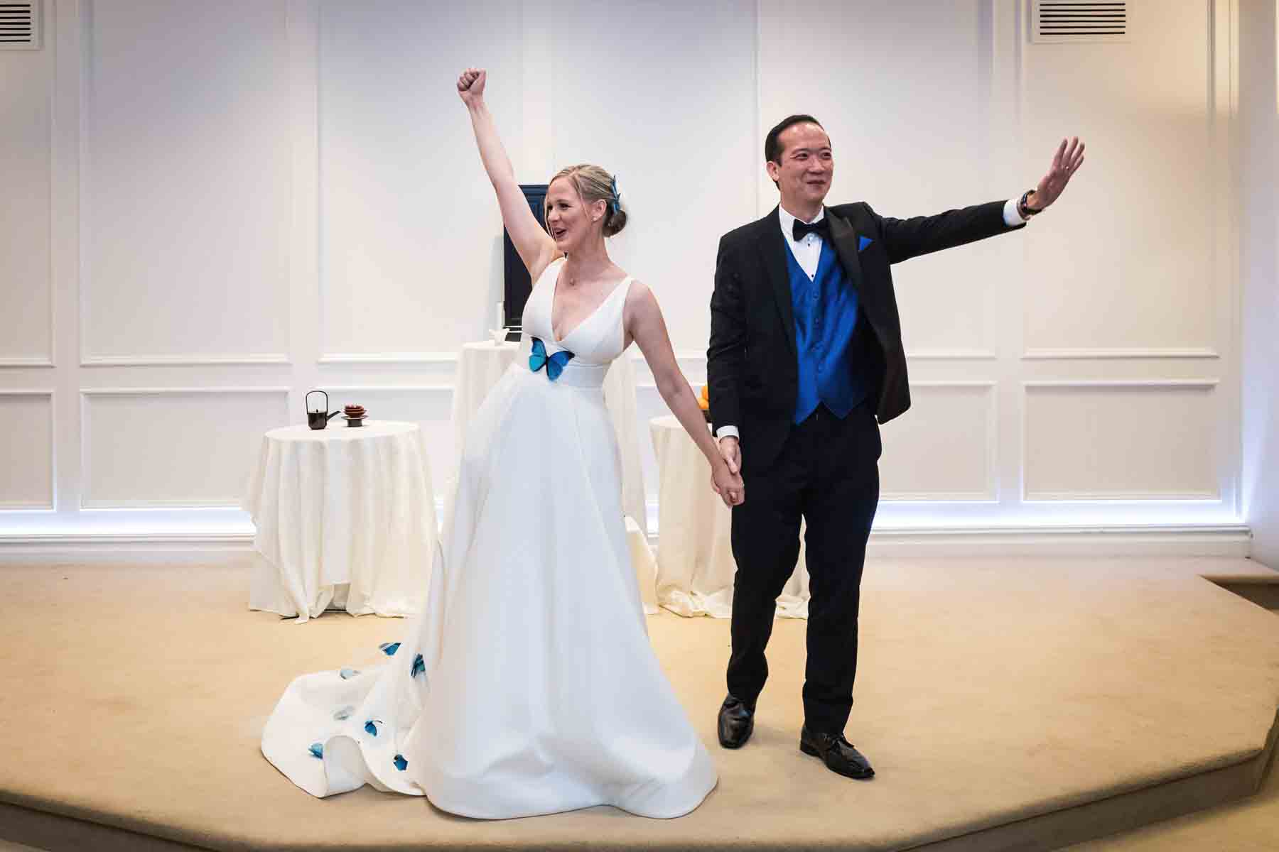 Bride and groom with arms raised excited after ceremony at a Terrace on the Park wedding