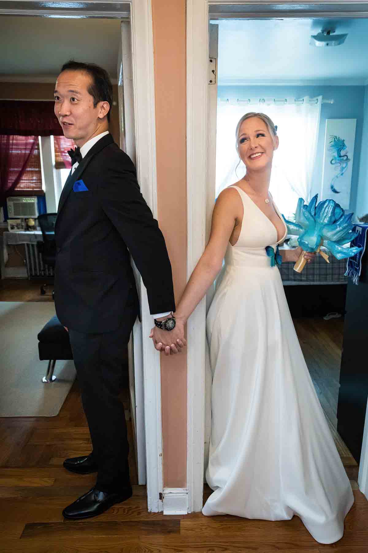 Bride and groom holding hands in doorway