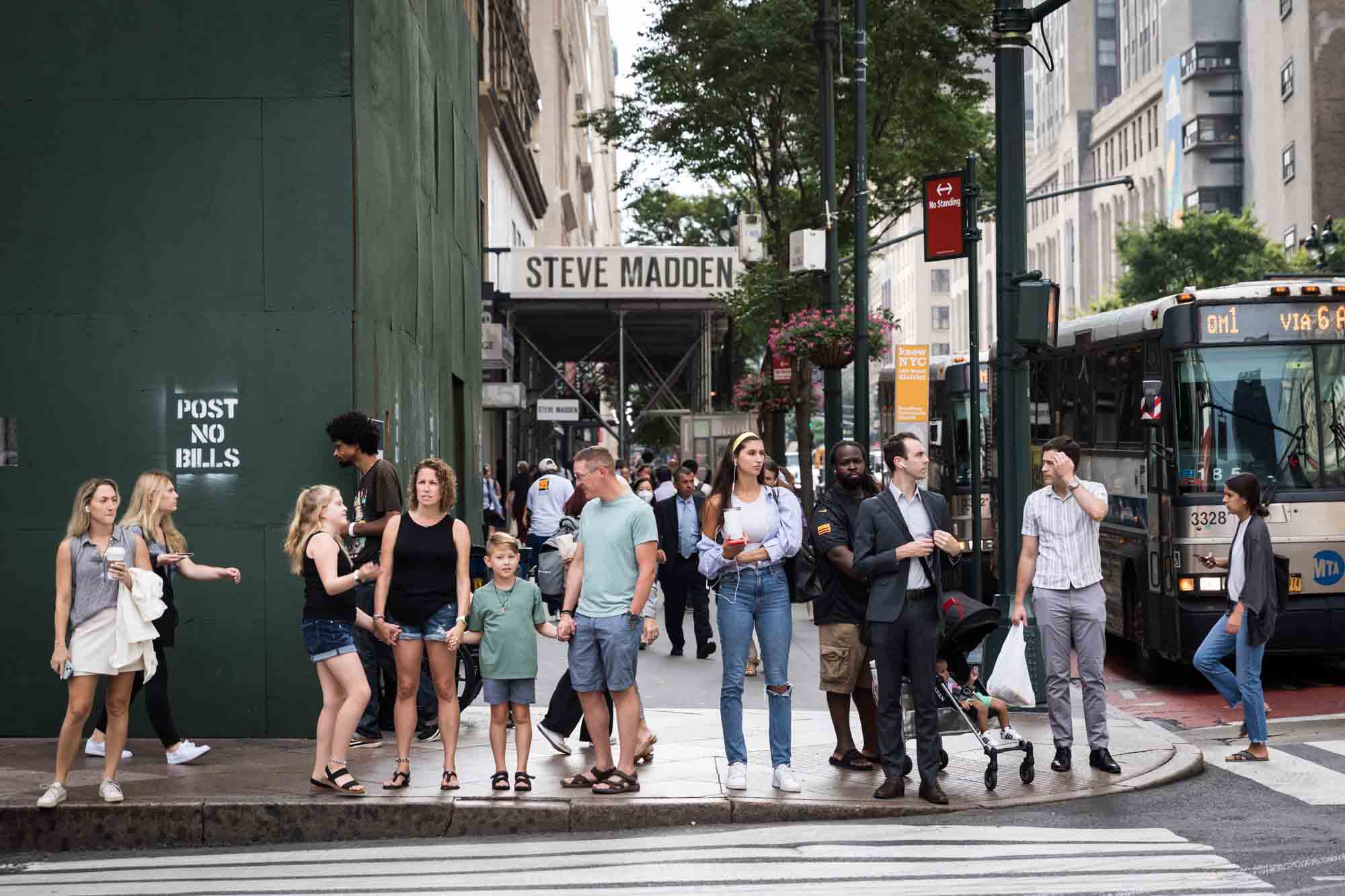 Parents and two kids standing on NYC corner for an article on best Manhattan family portrait locations