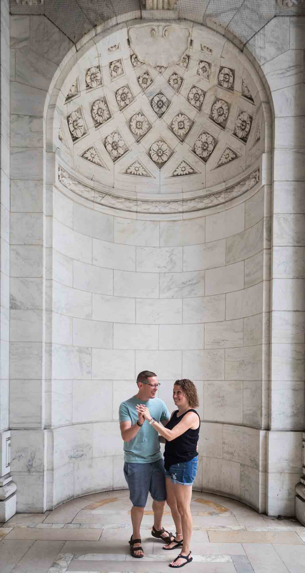 Parents dancing in front of New York Public Library