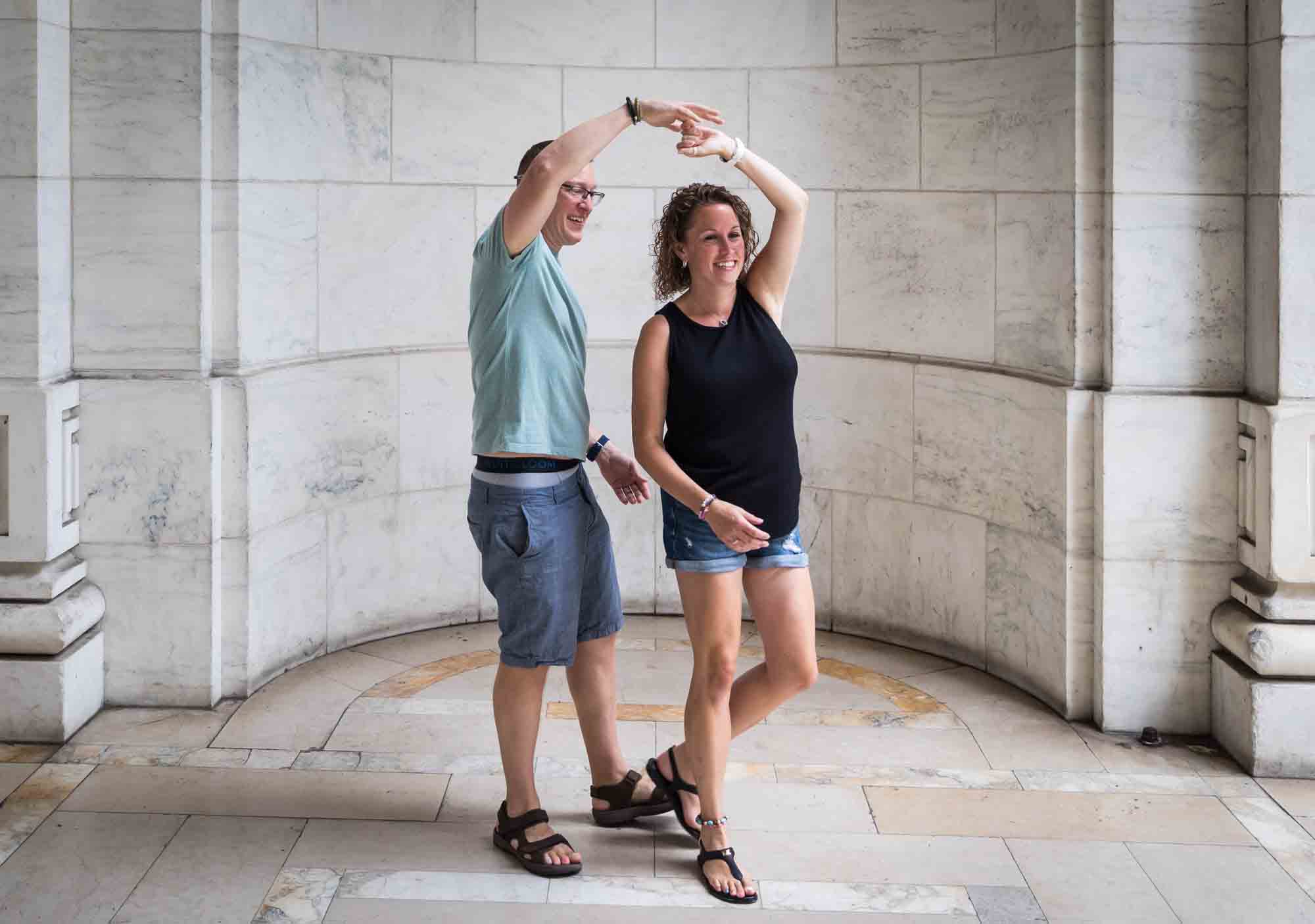 Parents dancing in front of New York Public Library