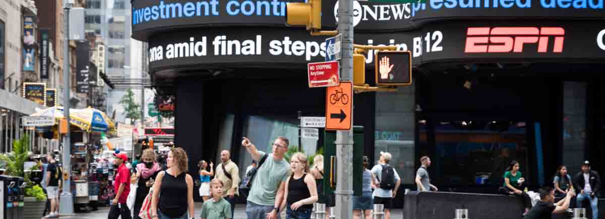 Parents and two kids on street corner in Times Square for an article on best Manhattan family portrait locations