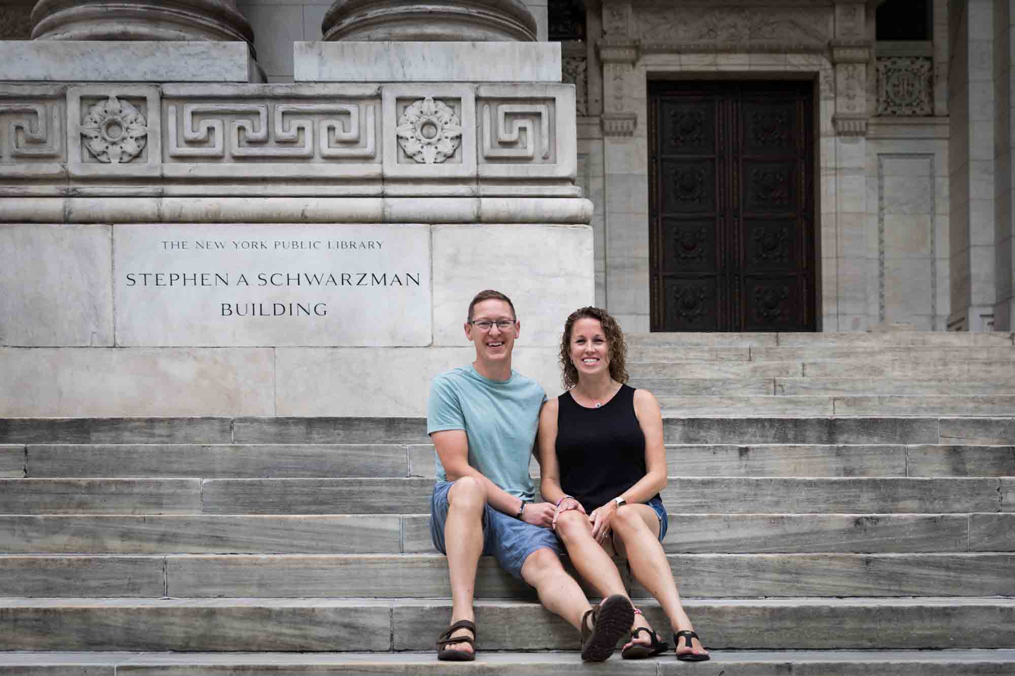 Parents sitting together on steps of New York Public Library