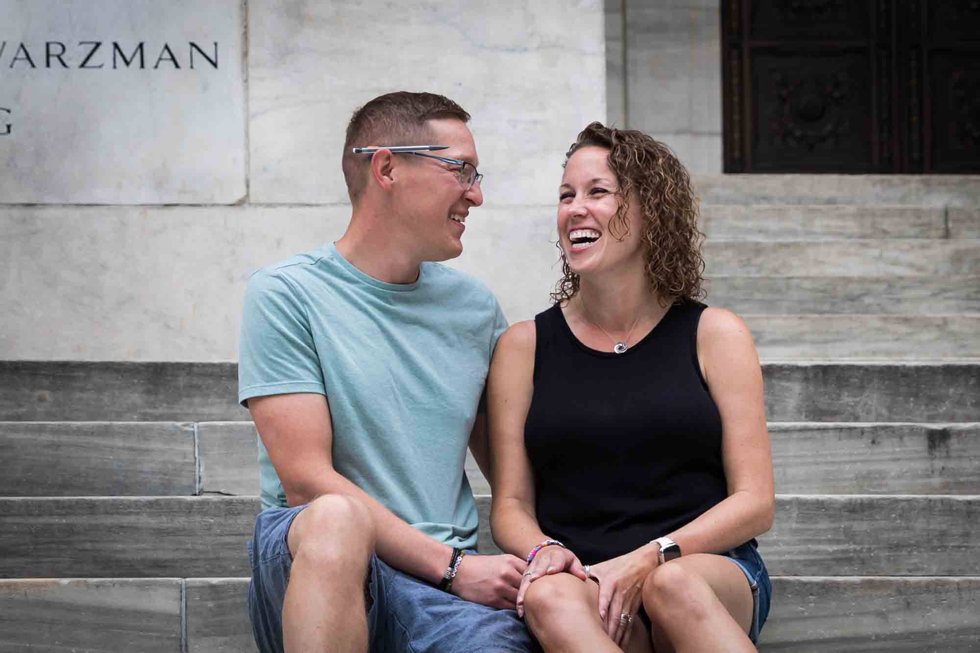 Parents sitting together on steps of New York Public Library