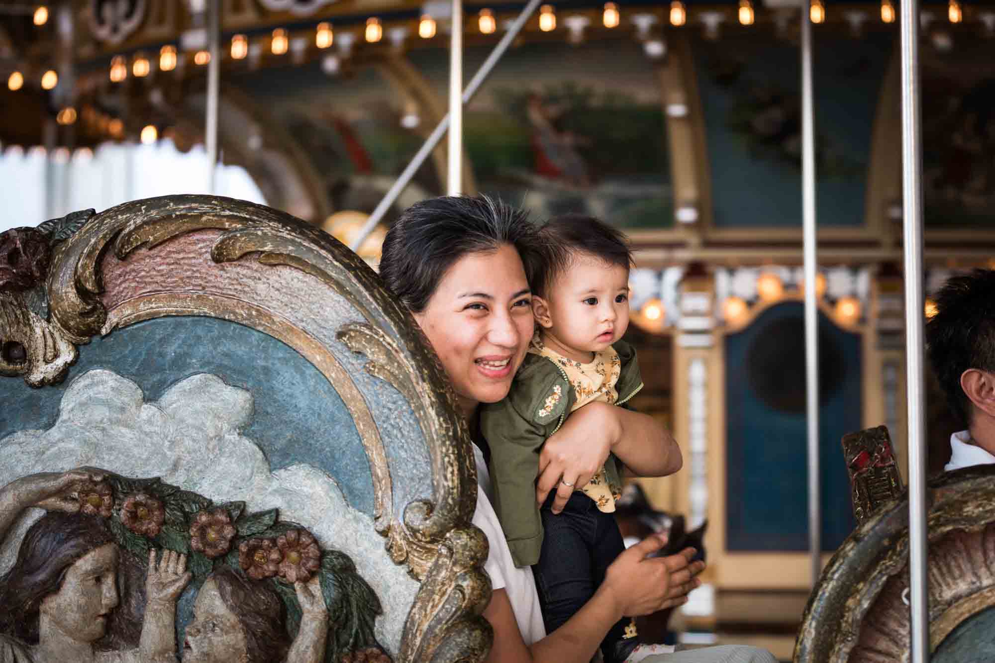 Mother holding daughter on Jane's Carousel