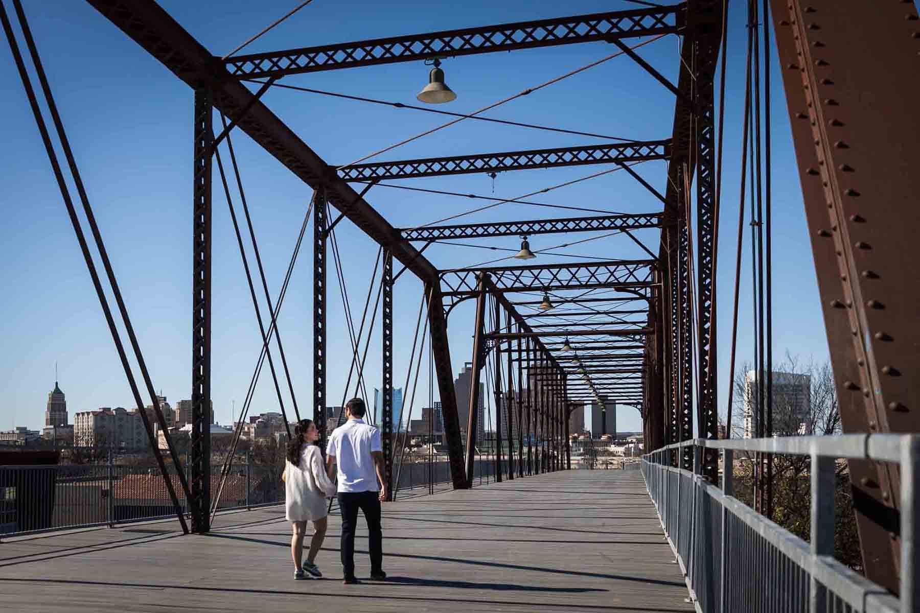 Couple walking to center of bridge for a Hays Street Bridge proposal