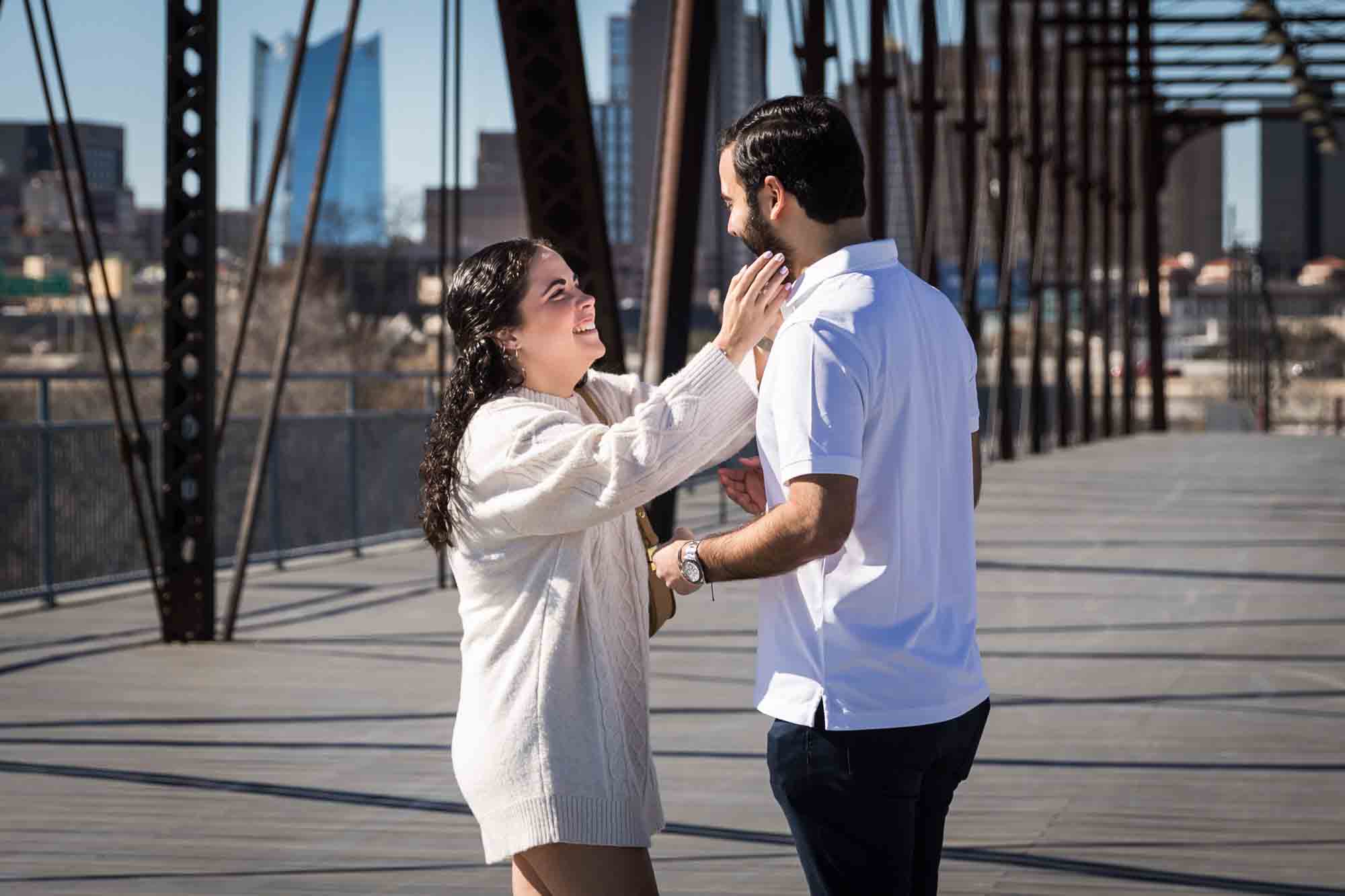 Woman reaching for man on bridge during a Hays Street Bridge proposal