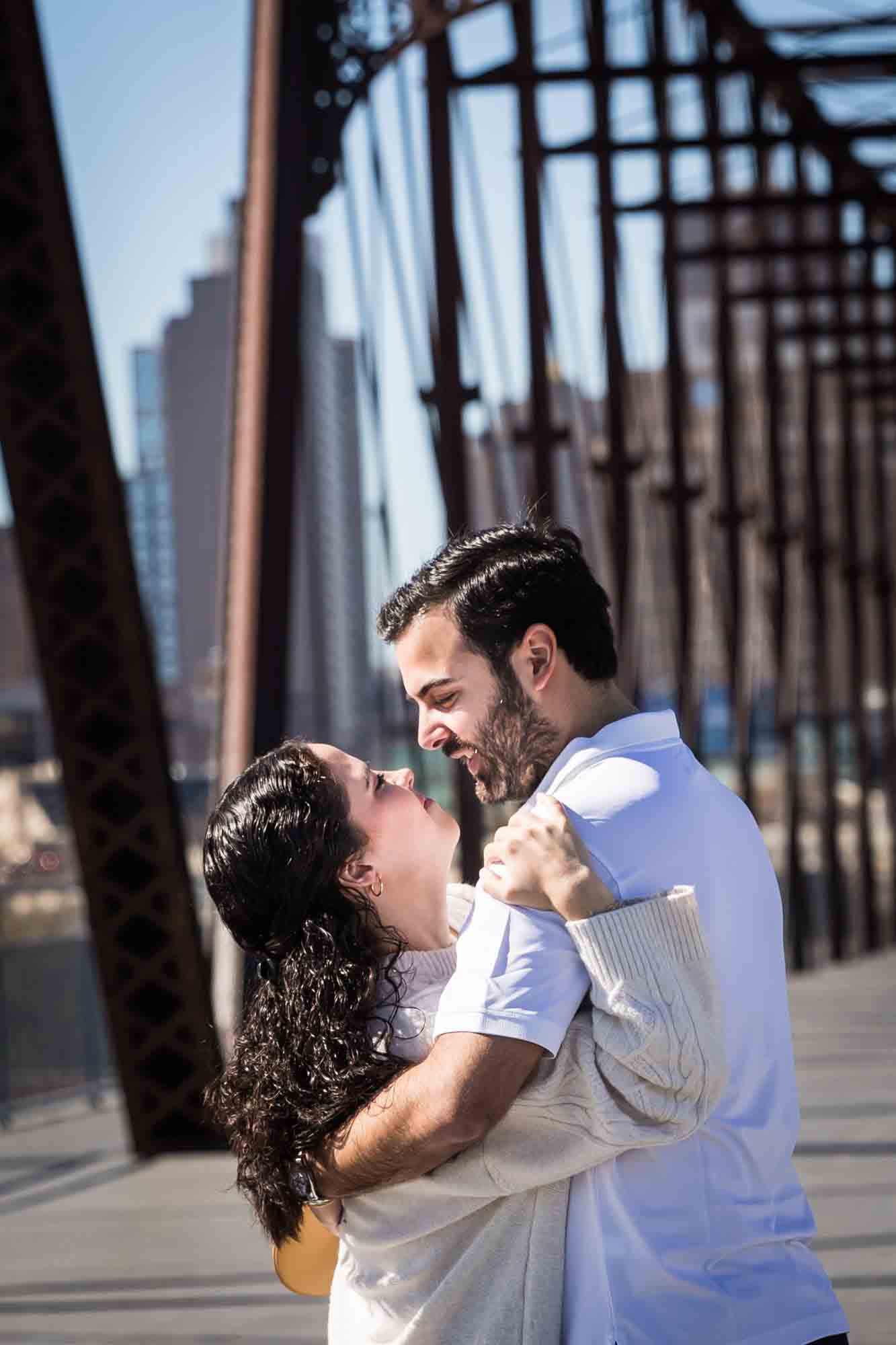 Couple hugging on bridge during a Hays Street Bridge proposal