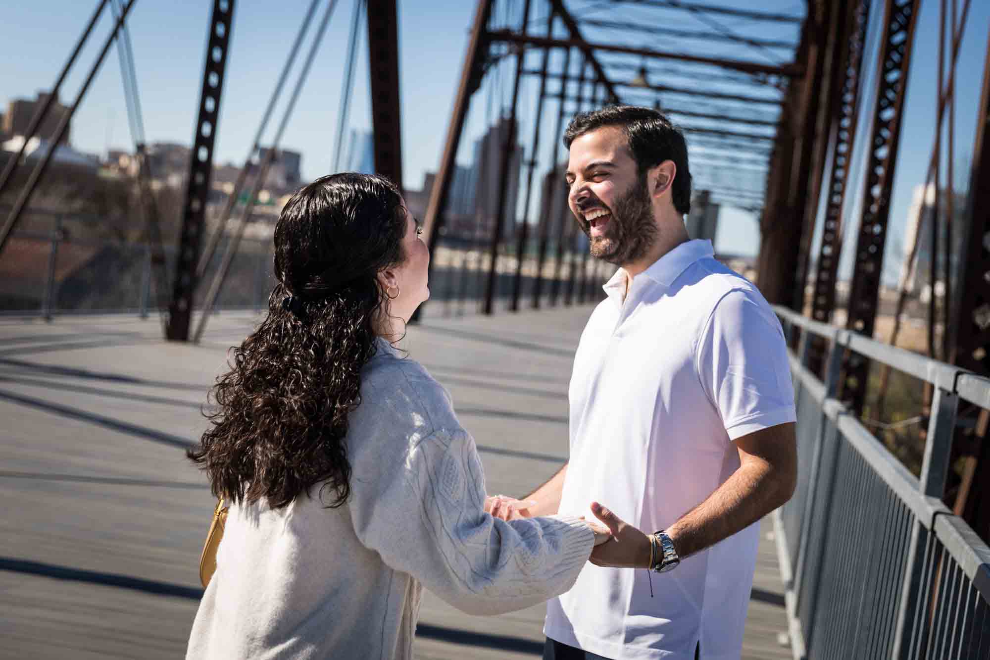 Couple holding hands on bridge during a Hays Street Bridge proposal