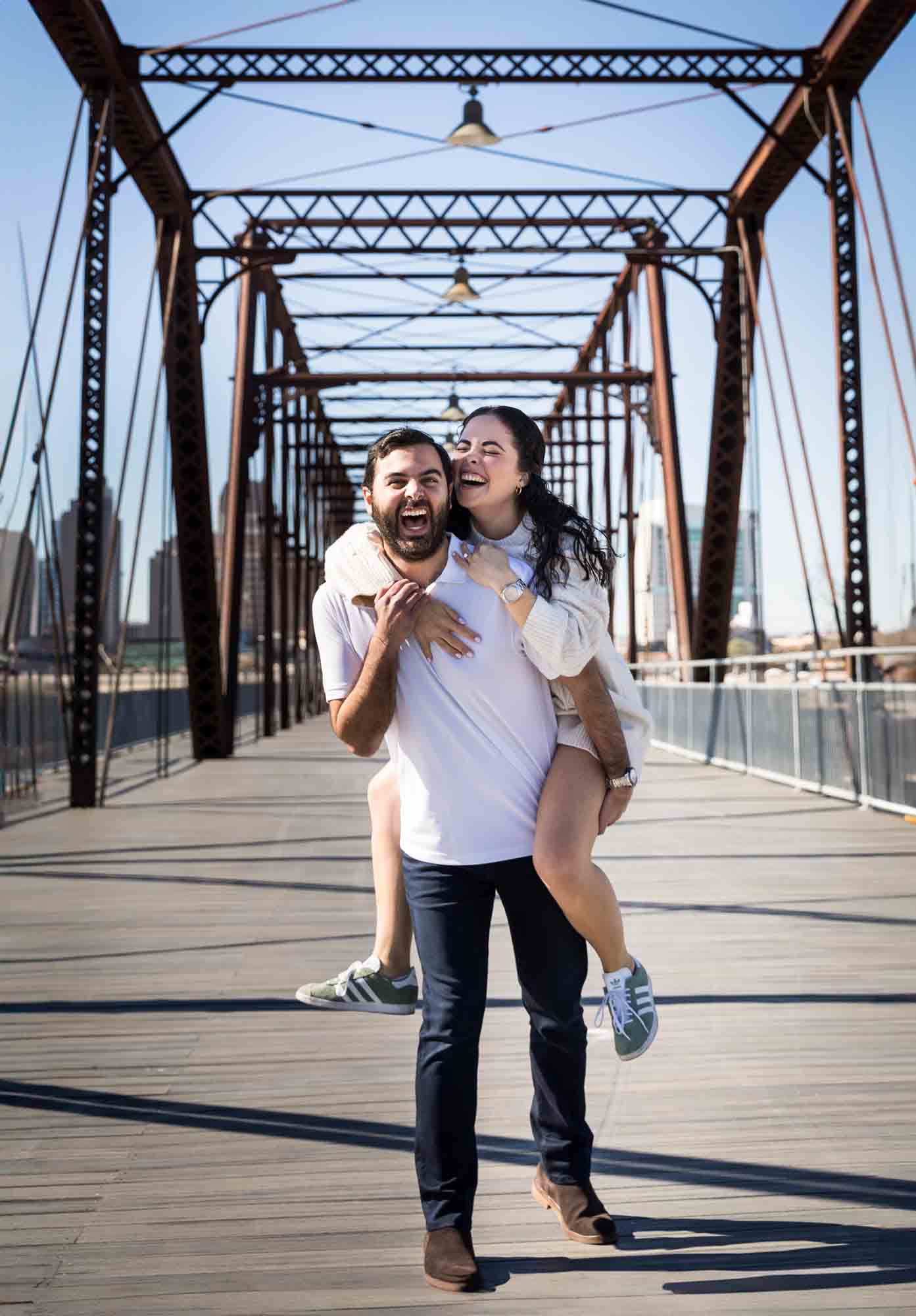 Man giving woman a piggyback ride on the bridge during a Hays Street Bridge proposal