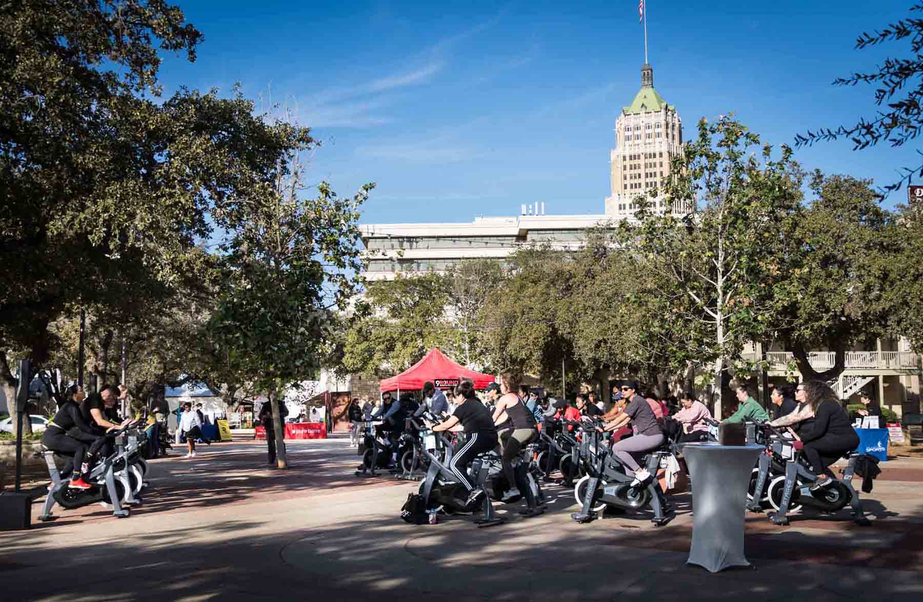 Group of people on stationery bikes in La Villita by San Antonio photographer, Kelly Williams