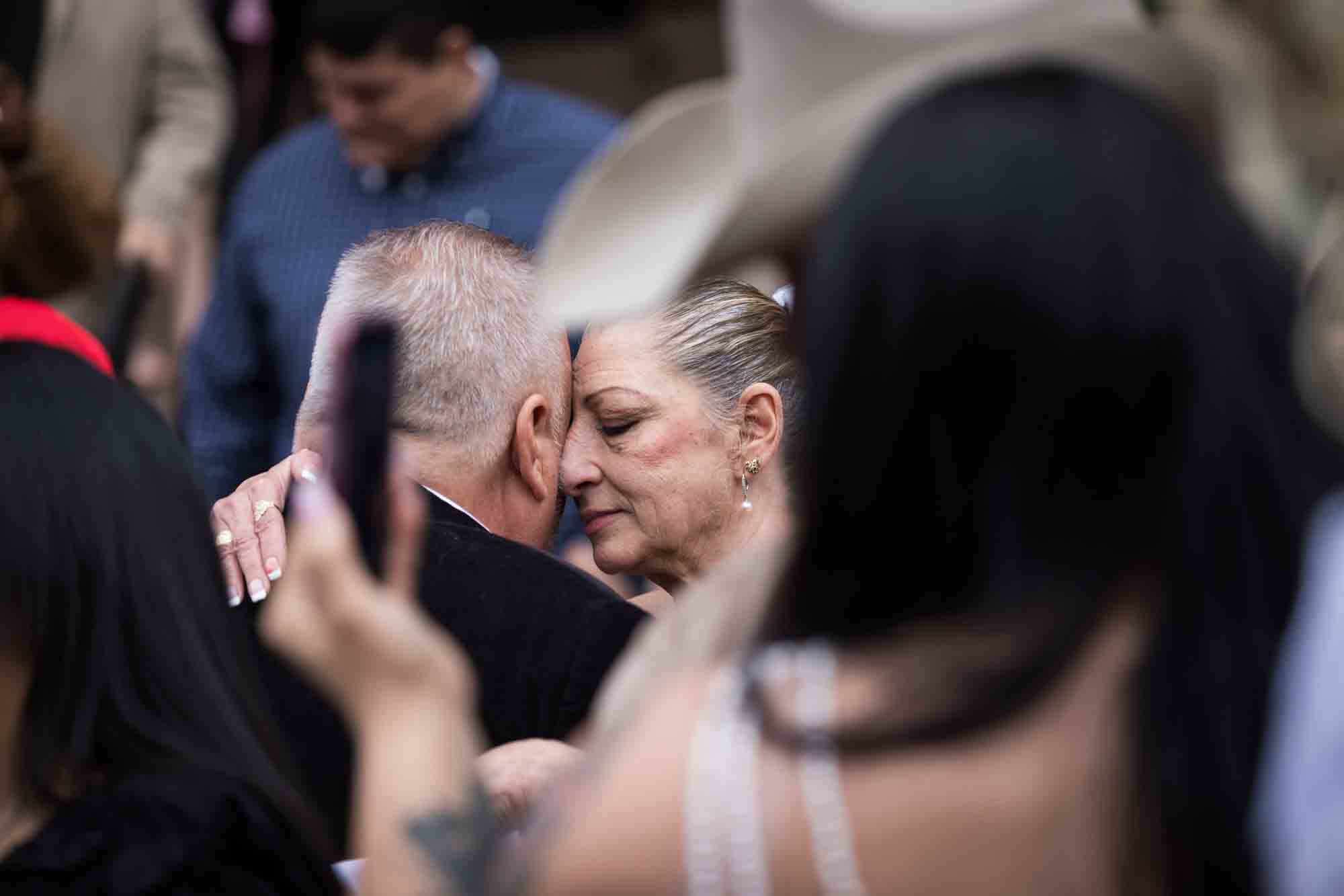 Older couple dancing close in a crowd