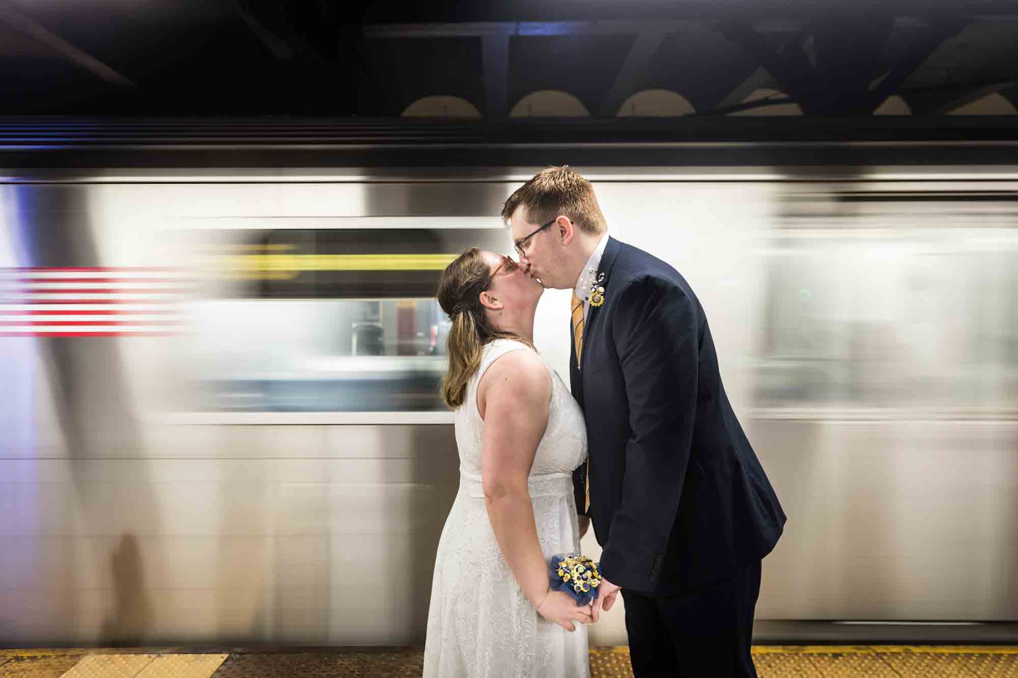 Couple kissing with subway train going by in a blur for an article on how to get a marriage license in San Antonio
