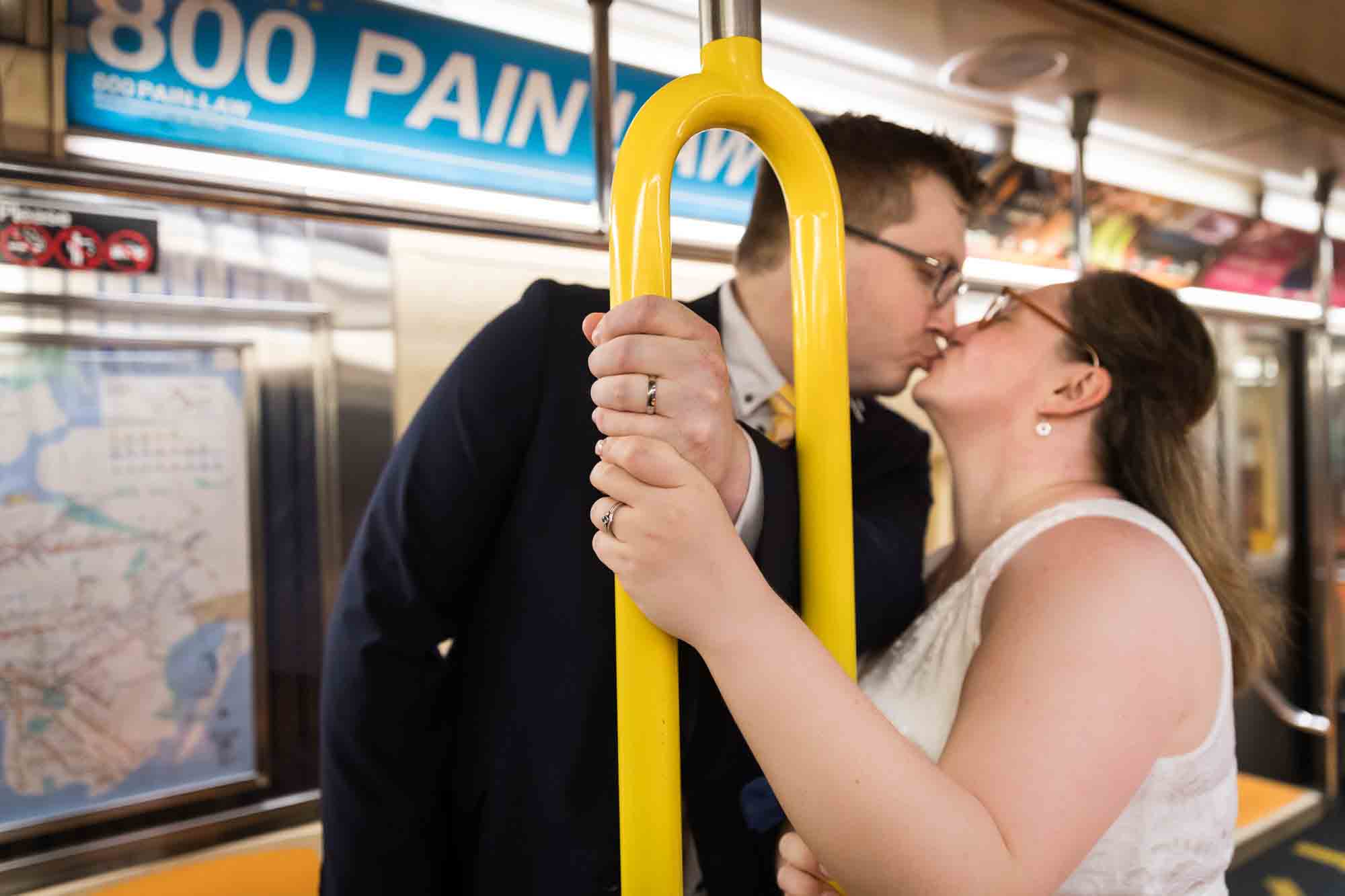 Couple kissing while holding on to subway bannister showing wedding rings for an article on how to get a marriage license in San Antonio