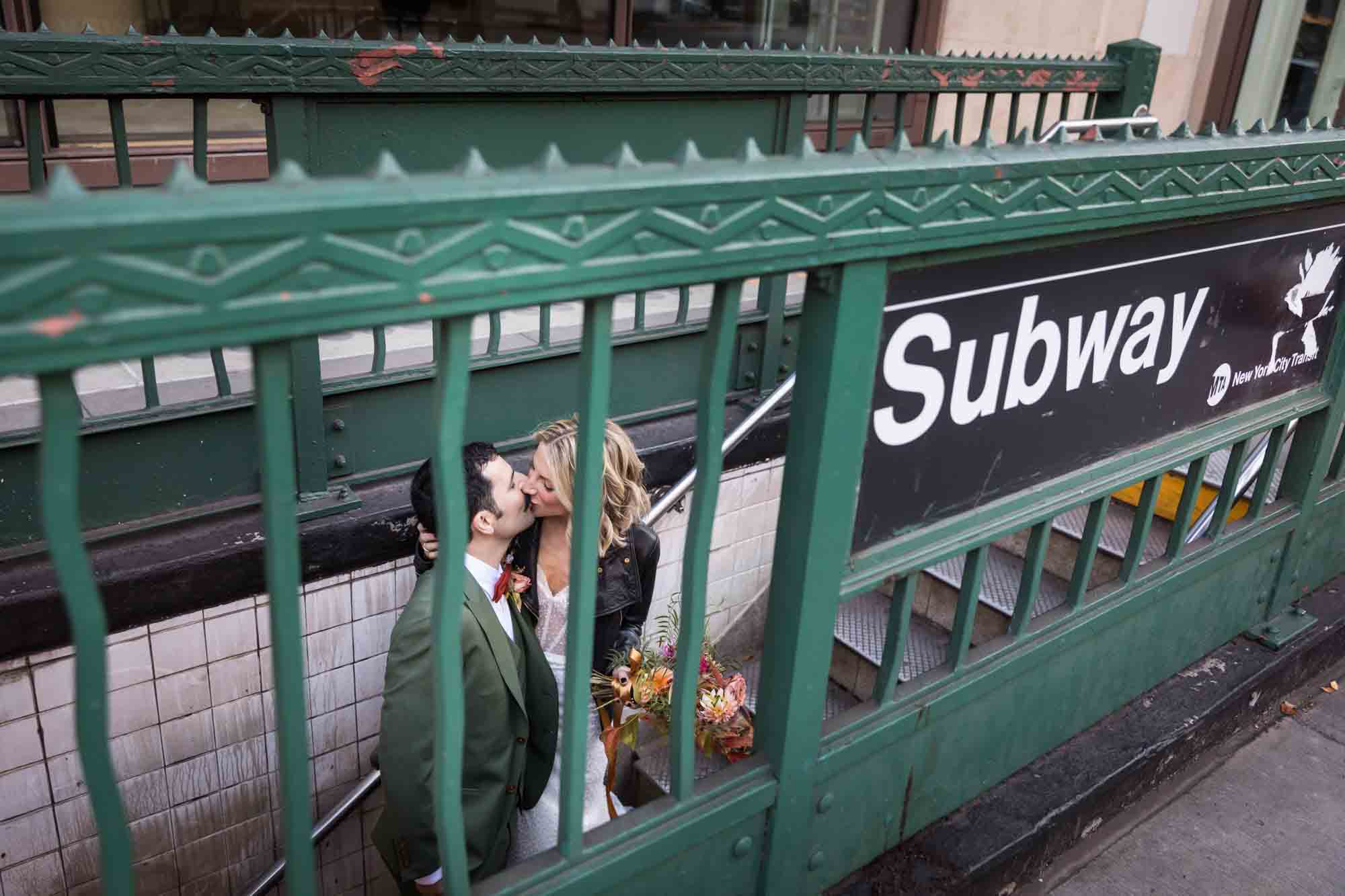 Bride and groom kissing on subway stairs for an article on should you give your wedding photographer a shot list