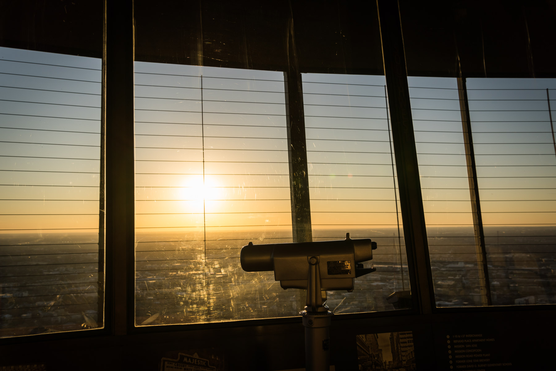 Viewer on the observation deck of the Tower of the Americas at sunset