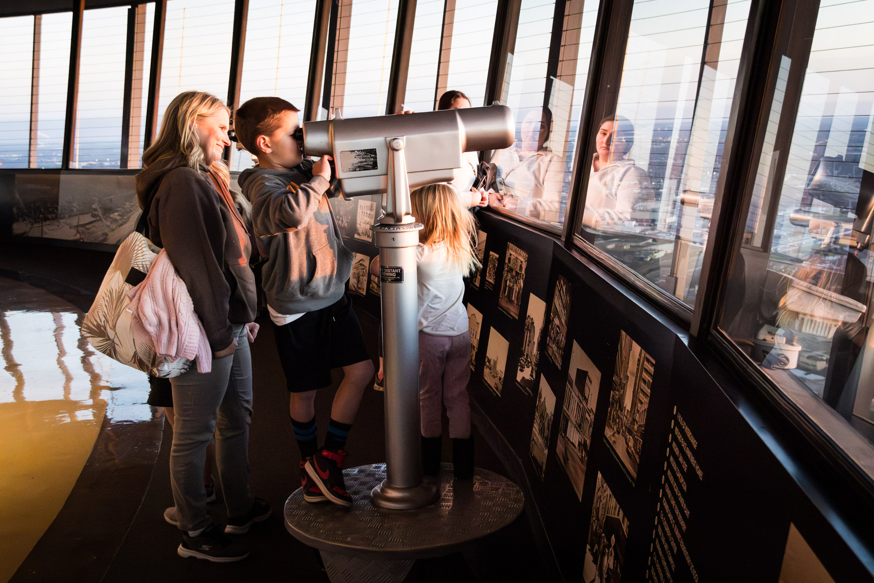 Family looking through viewer on the observation desk of the Tower of the Americas