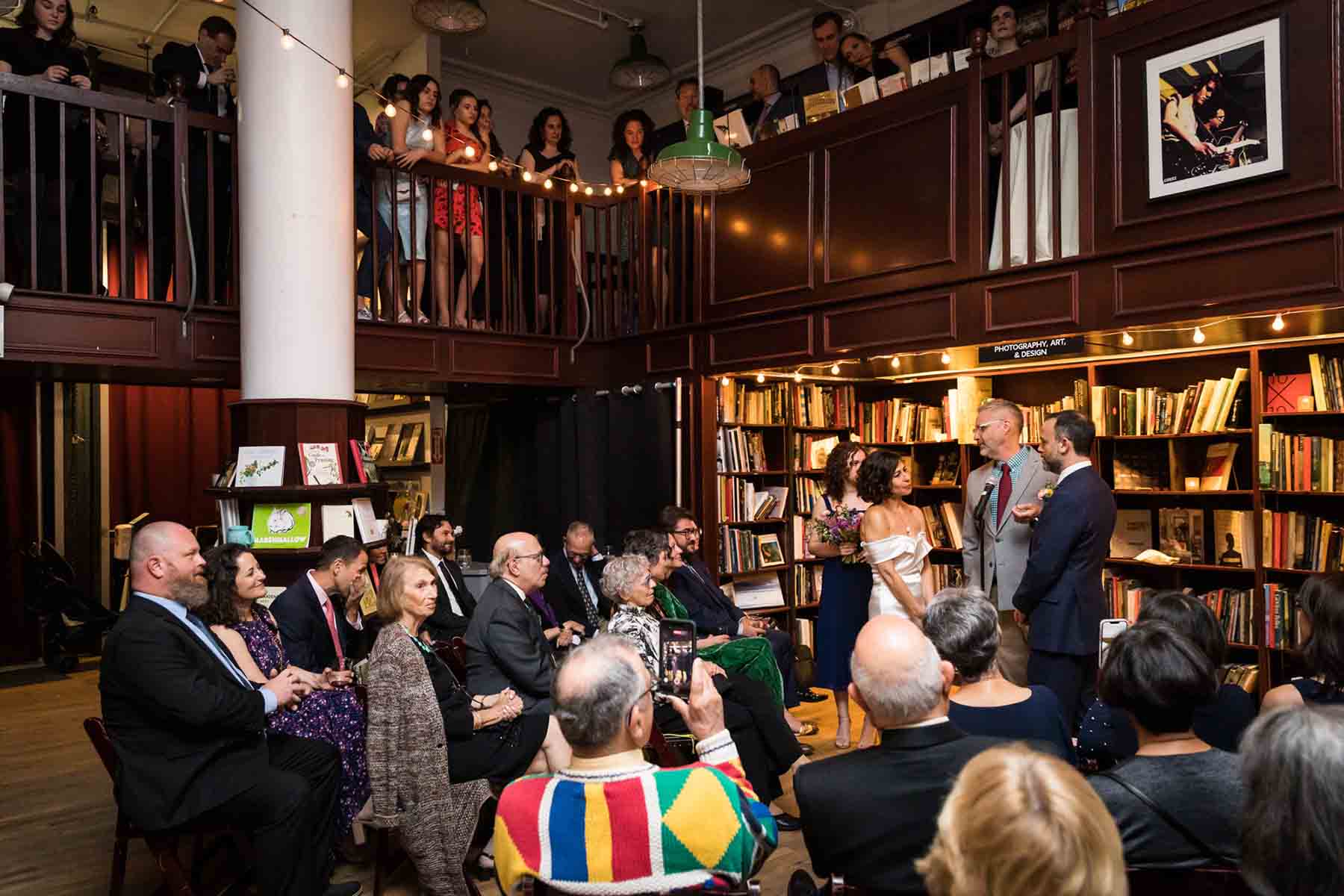 Wedding ceremony at a two-level bookstore for an article on the best wedding jobs for family and friends