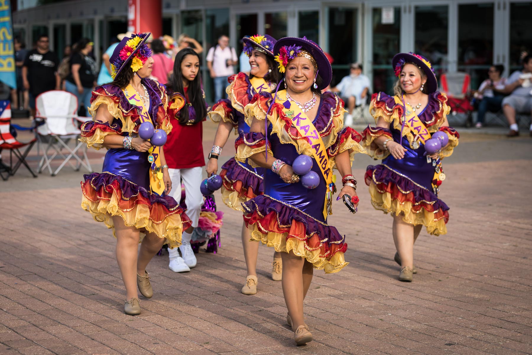 Colorful female dancers walking during Fiesta Fiesta for an article on the best Fiesta photos